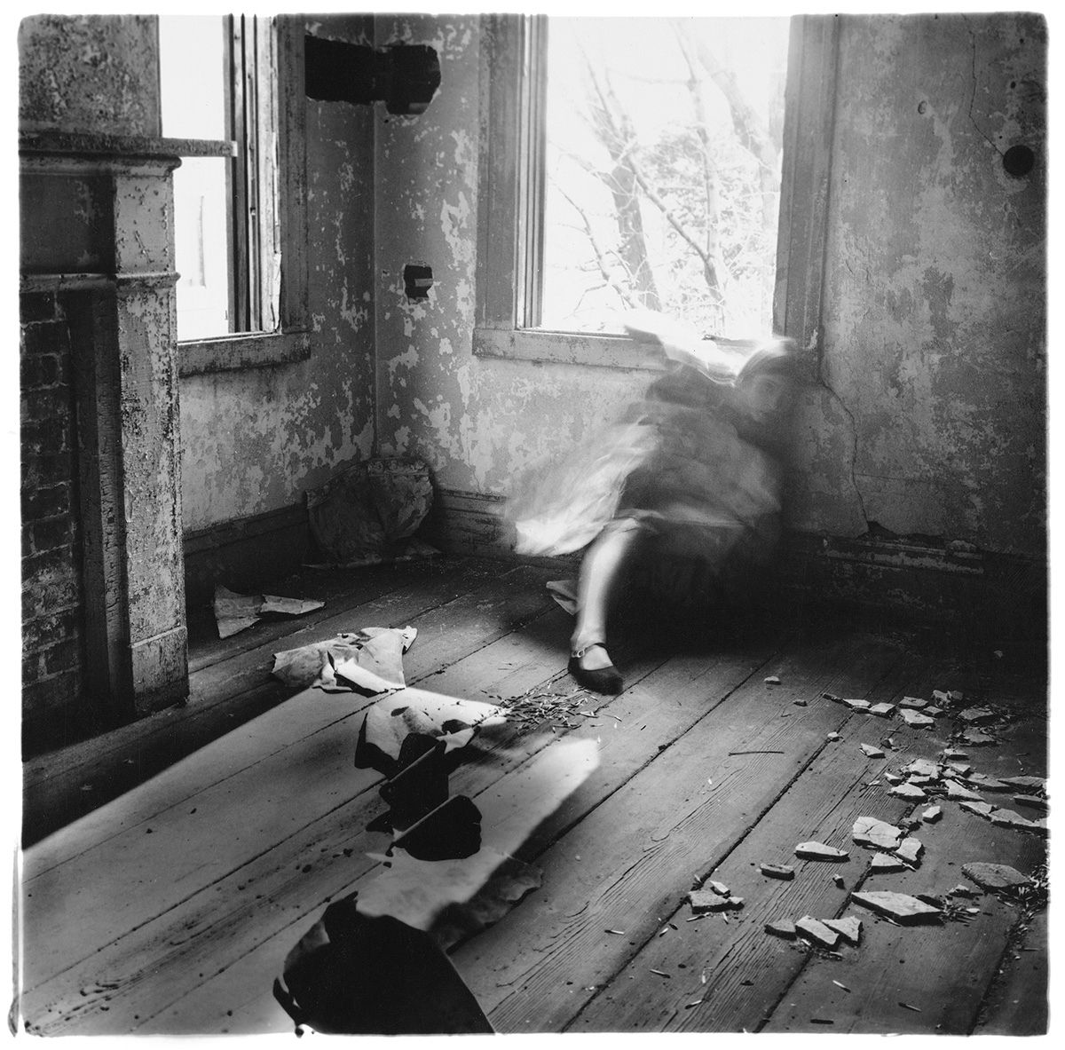 A series of black and white photos showing an abandoned room with debris and deteriorating walls in dim lighting.