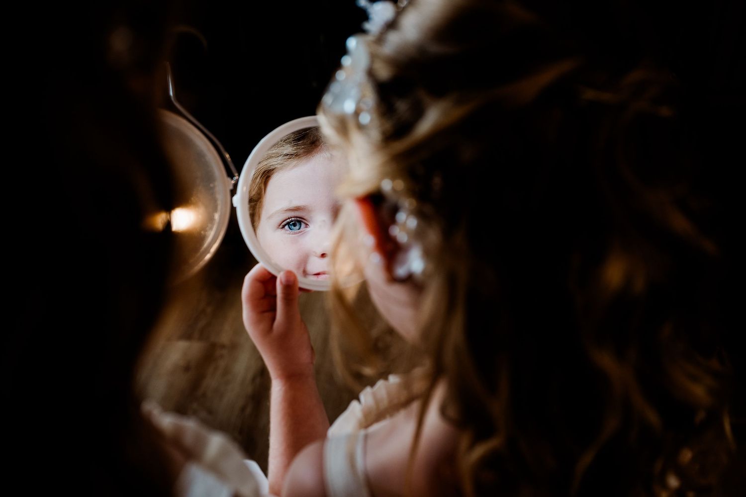 Romantic reflection in mirror during bridal preparation.