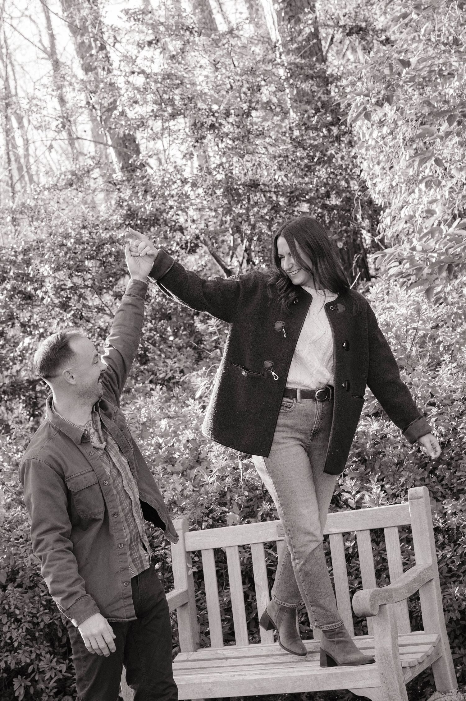 couple in charlotte north carolina park walking on a bench during a couples session