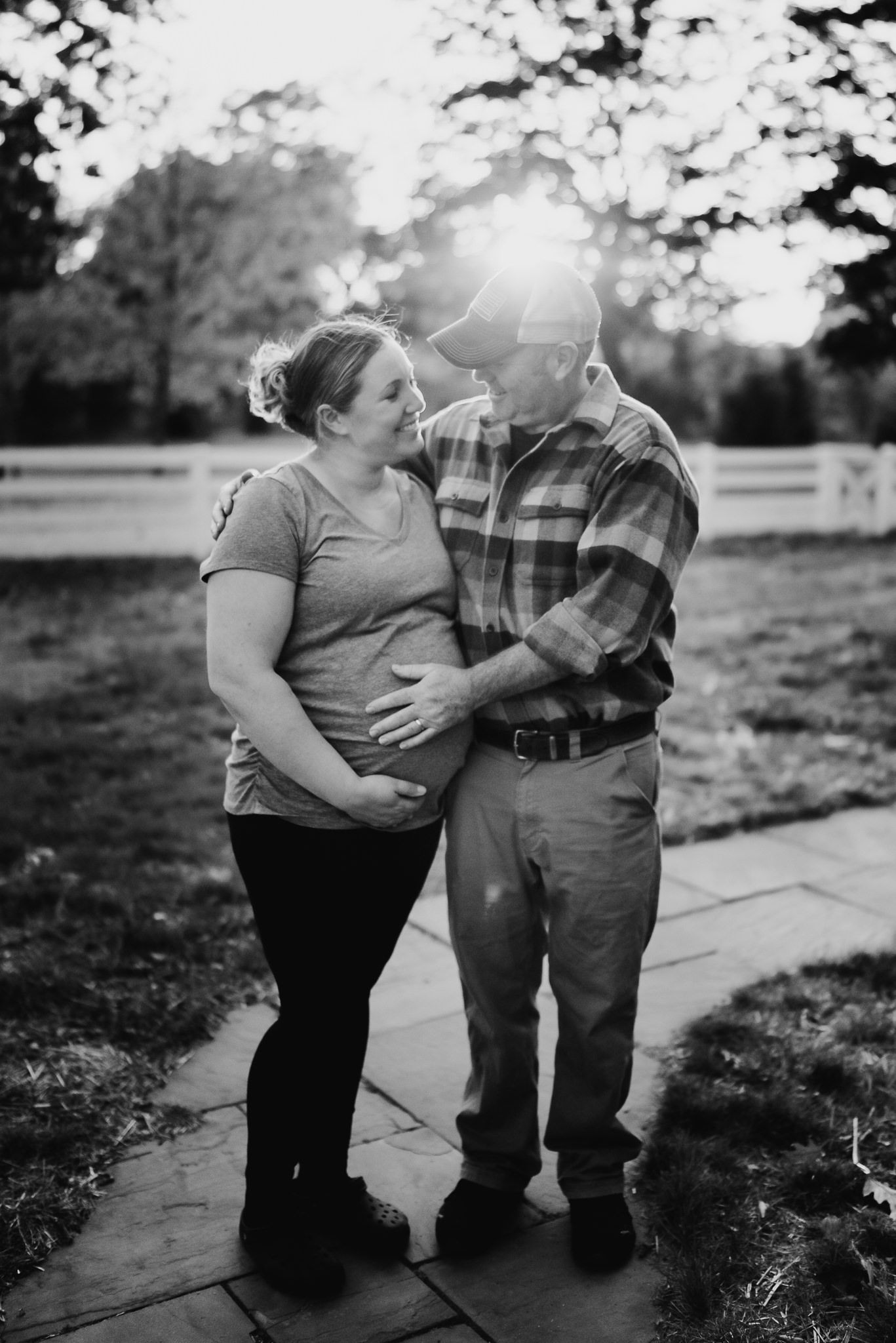 Intimate black and white portrait of couple sharing moment outdoors.