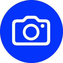 Blue circle icon featuring a white camera symbol, ideal for photography apps and social media platforms.