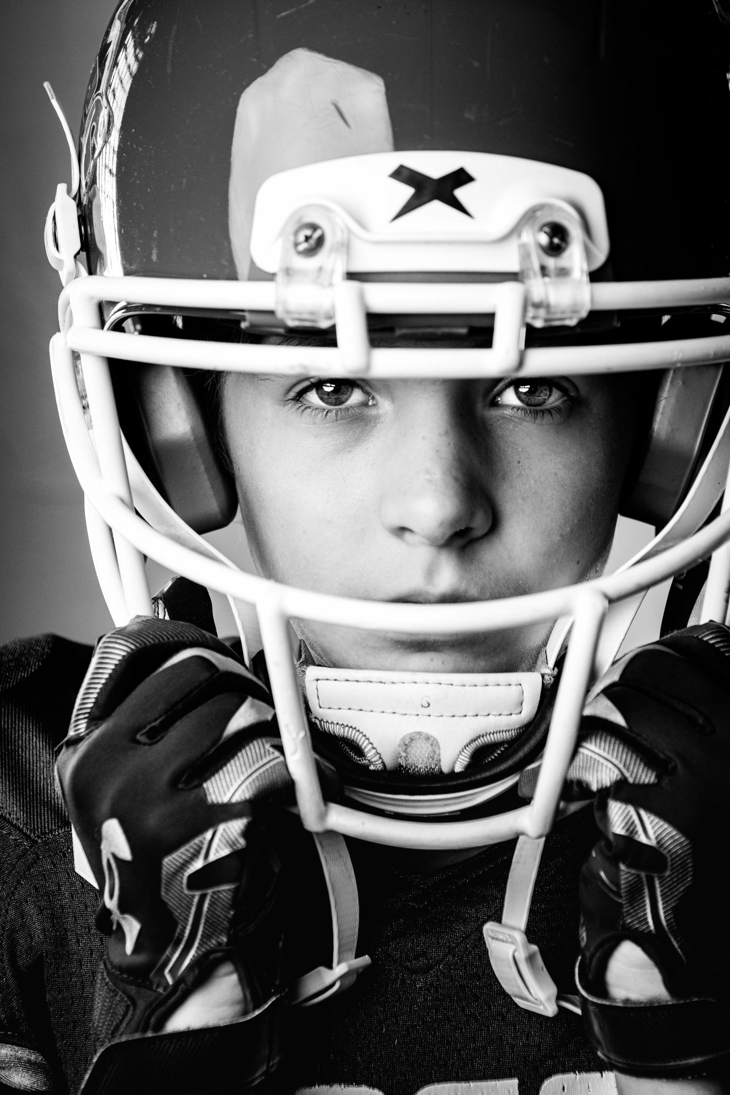 Artistic black and white series of football helmet facemask views.
