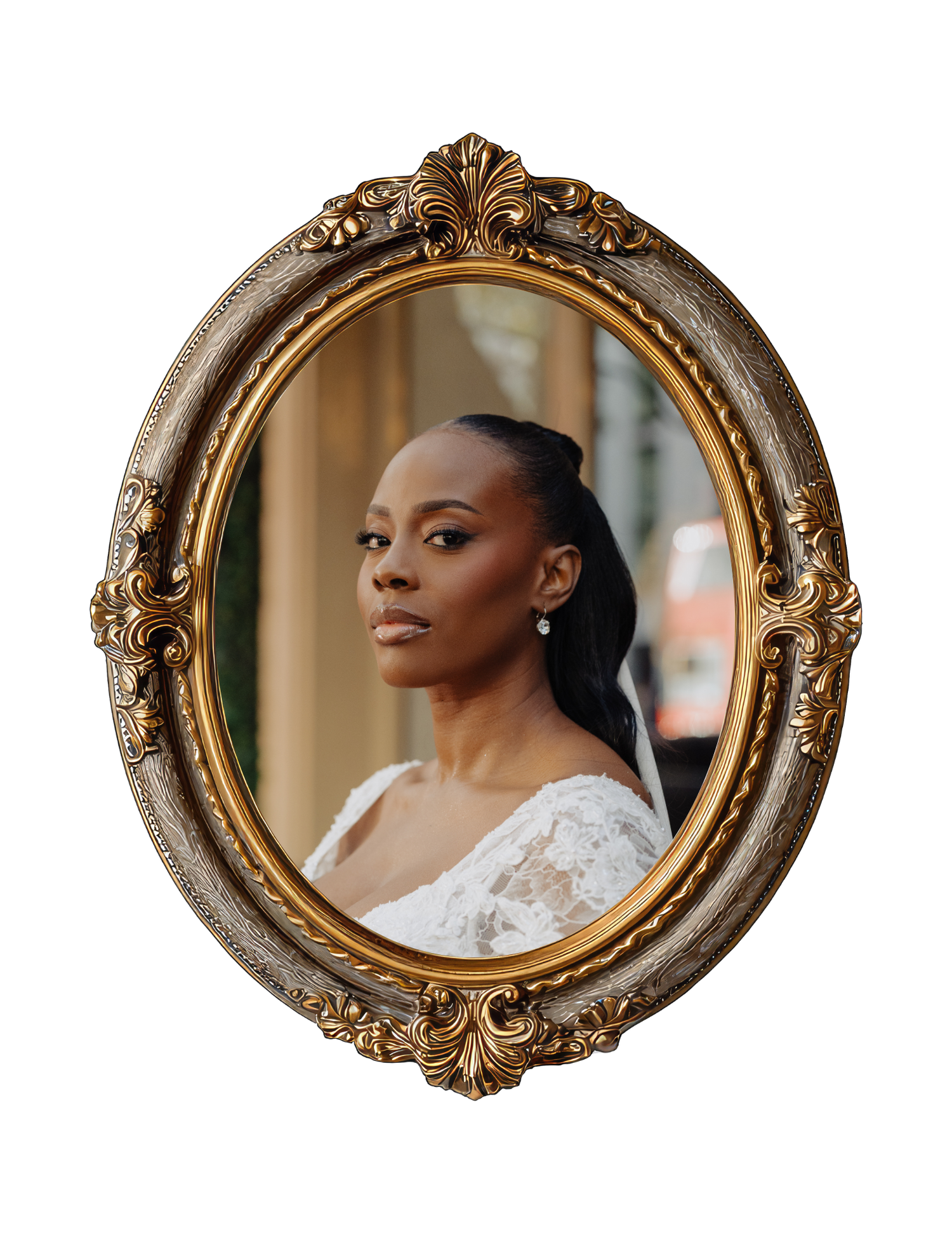 A Black woman in a white lace bridal gown poses elegantly inside an ornate gold oval vintage mirror frame.