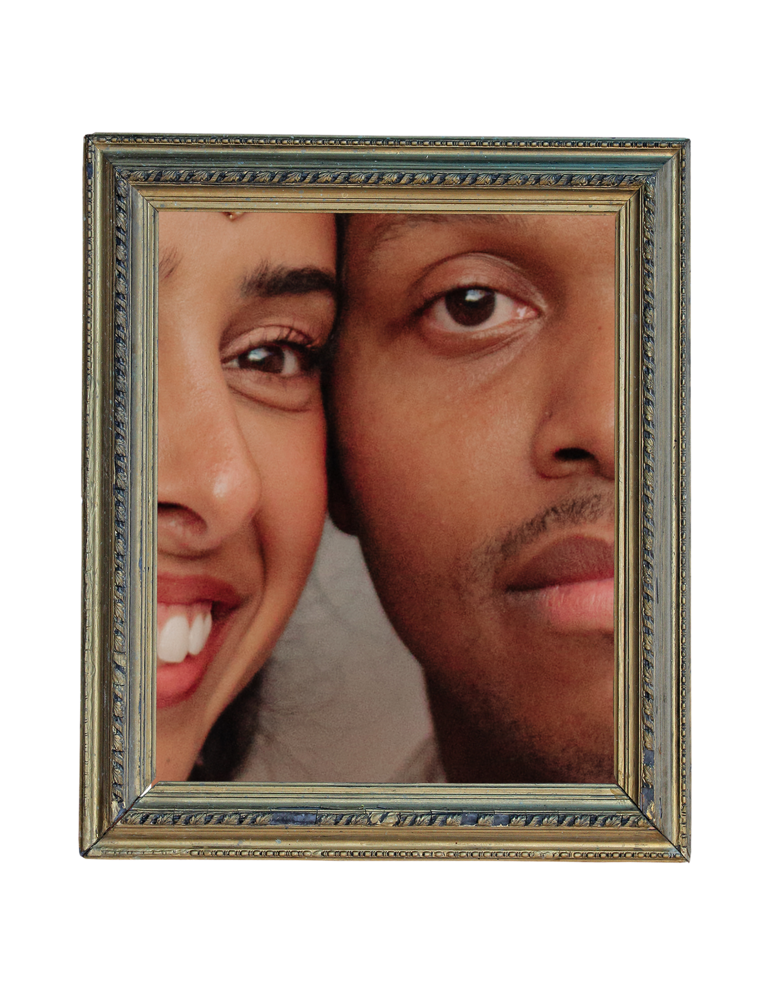 Close-up portrait of a smiling couple in an ornate vintage picture frame.