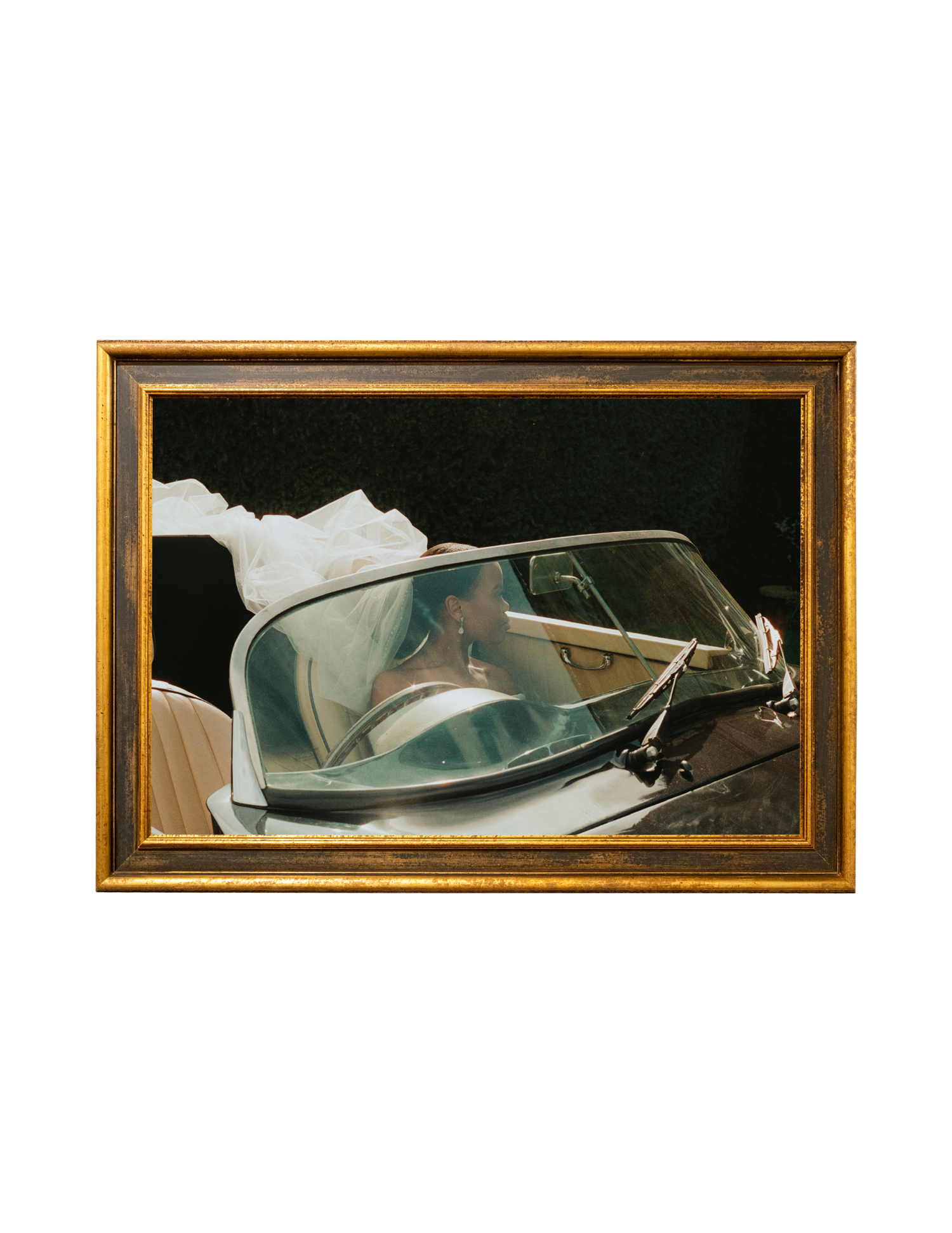 Framed painting of a vintage car windshield reflection with a figure, displayed in a gold ornate frame.