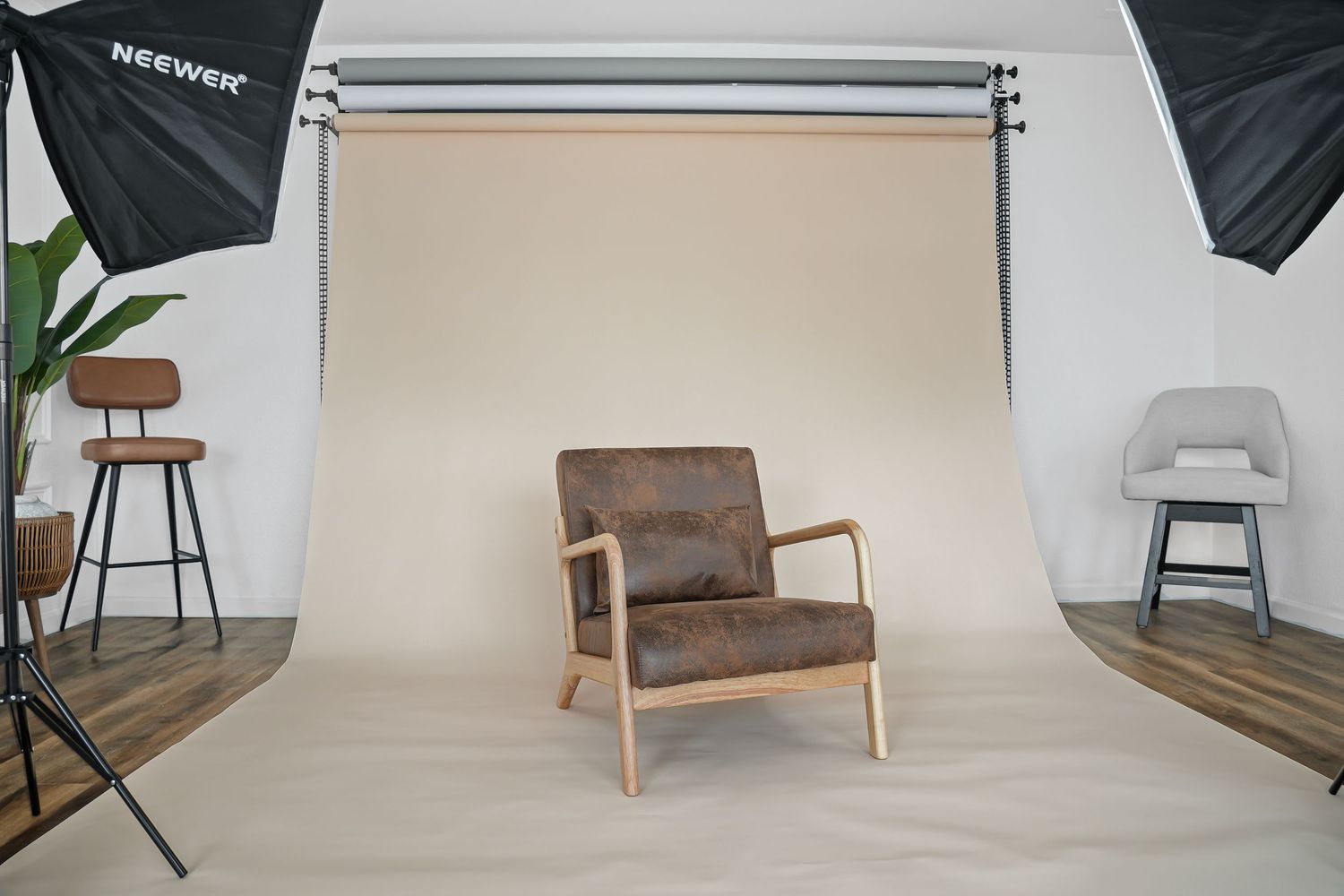 Brown leather accent chair with natural wood frame in professional photography studio setup.