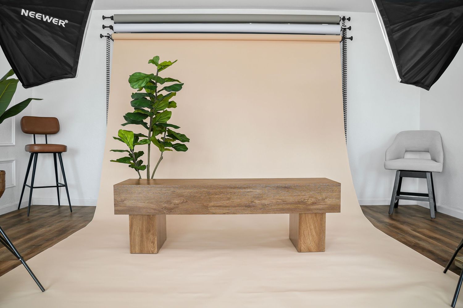 Solid wood rectangular bench with thick block legs in studio setting with tropical fiddle leaf plant.