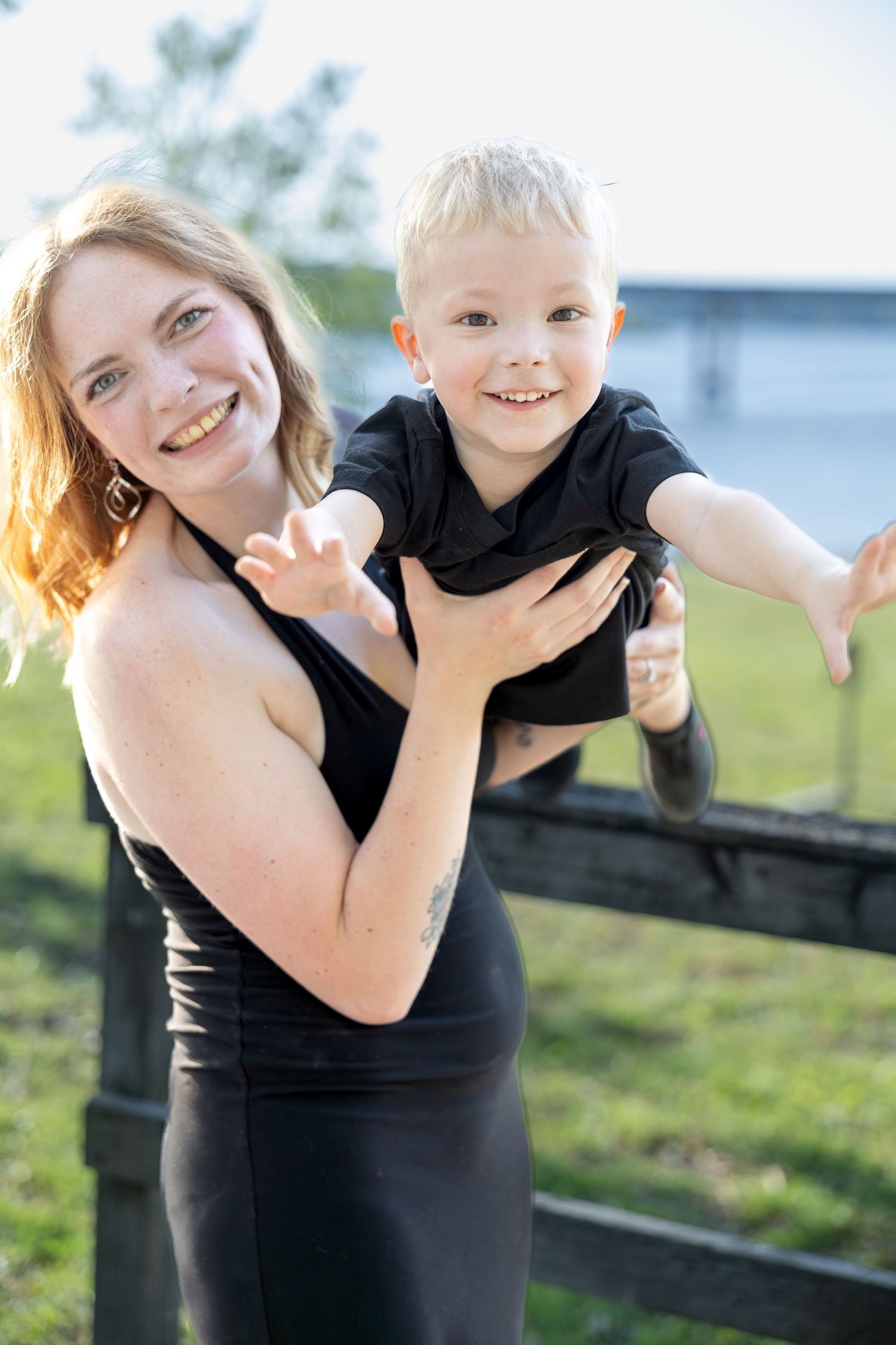 Family portrait session capturing genuine smiles, natural interactions, and timeless memories in a beautiful outdoor setting.