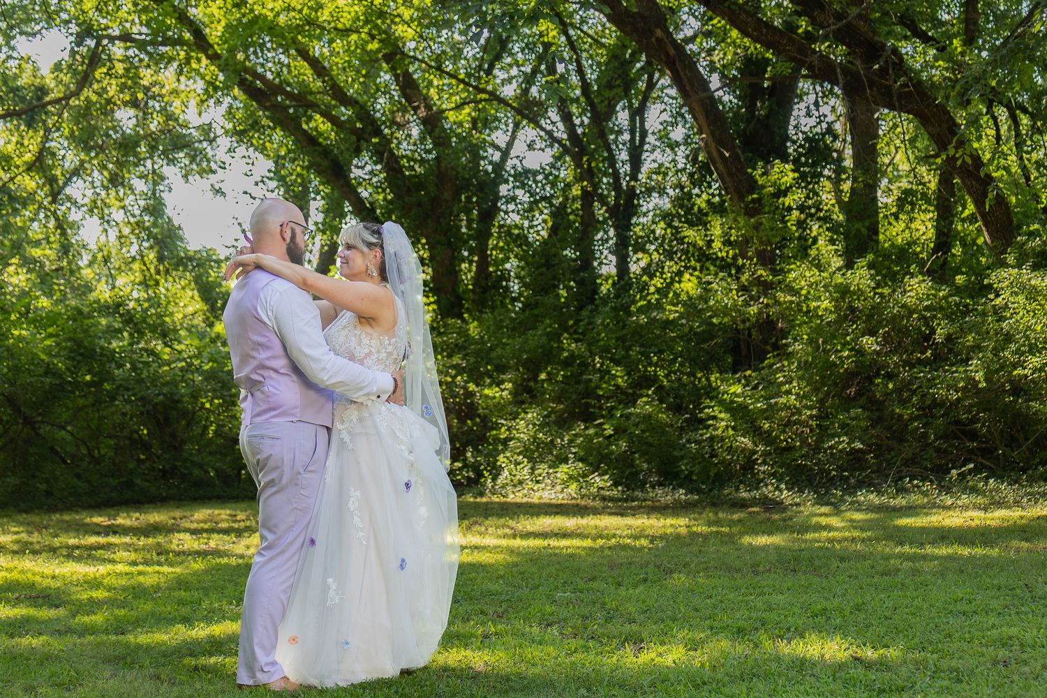 Bride and groom sharing joyful moments on their wedding day with timeless portraits, candid emotions, and elegant details.