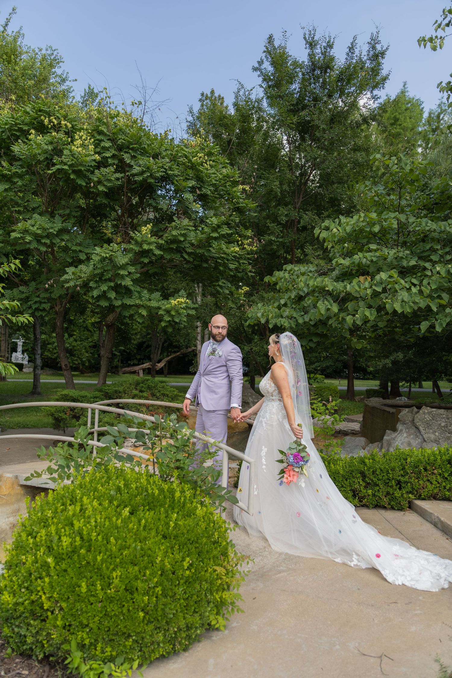 Bride and groom sharing joyful moments on their wedding day with timeless portraits, candid emotions, and elegant details.