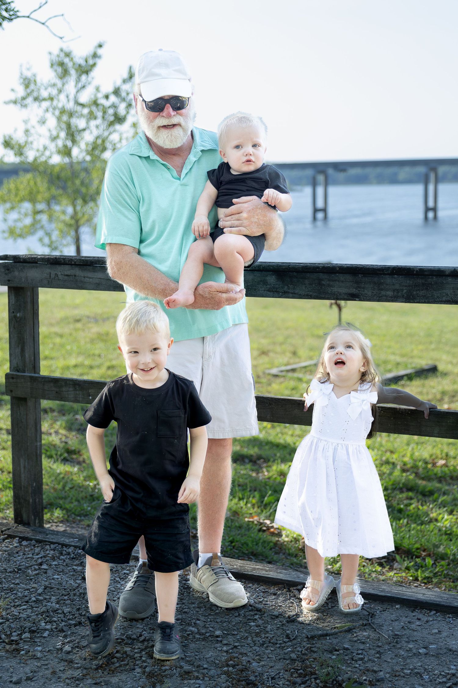 Family portrait session capturing genuine smiles, natural interactions, and timeless memories in a beautiful outdoor setting.