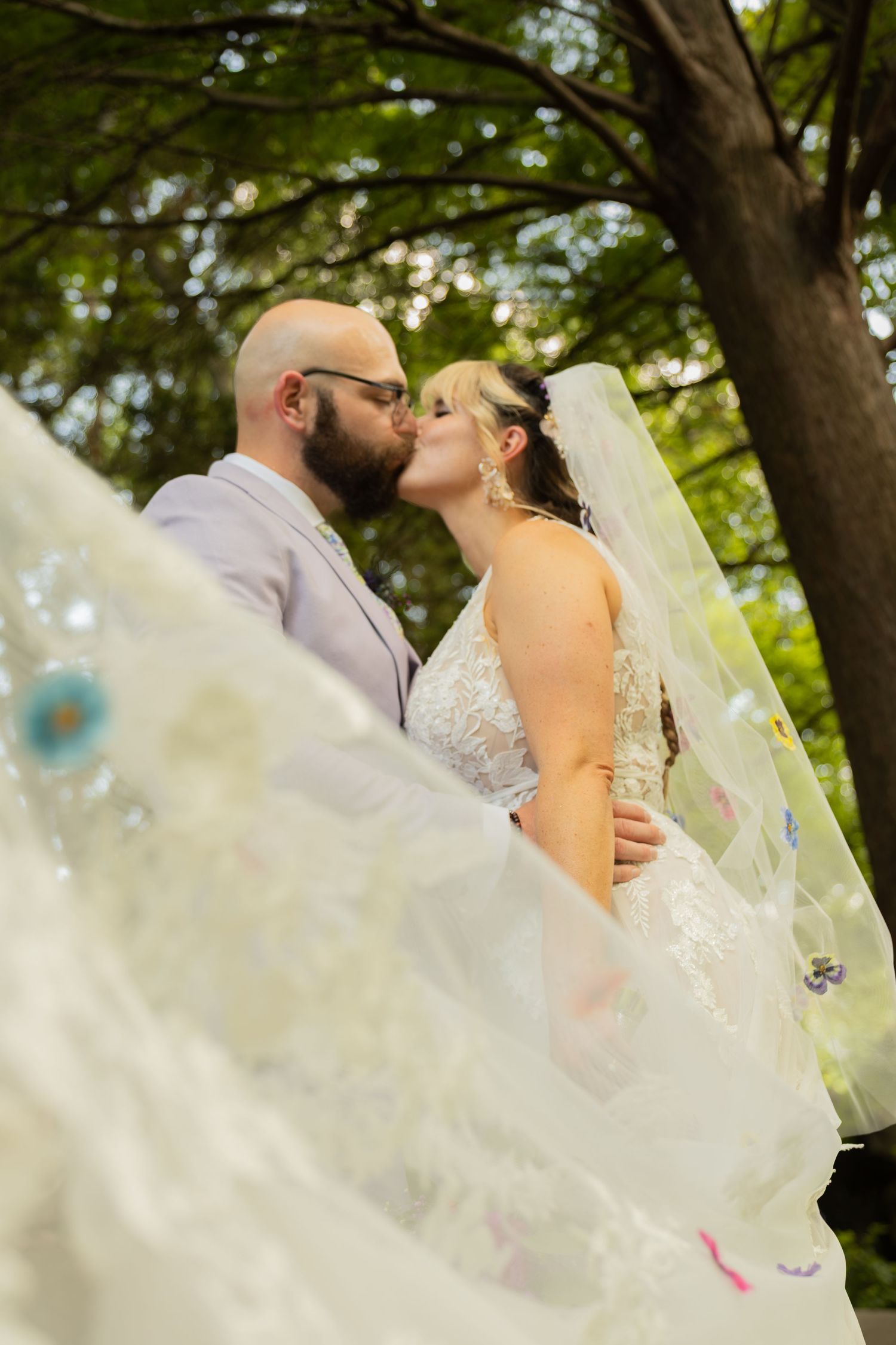 Bride and groom sharing joyful moments on their wedding day with timeless portraits, candid emotions, and elegant details.