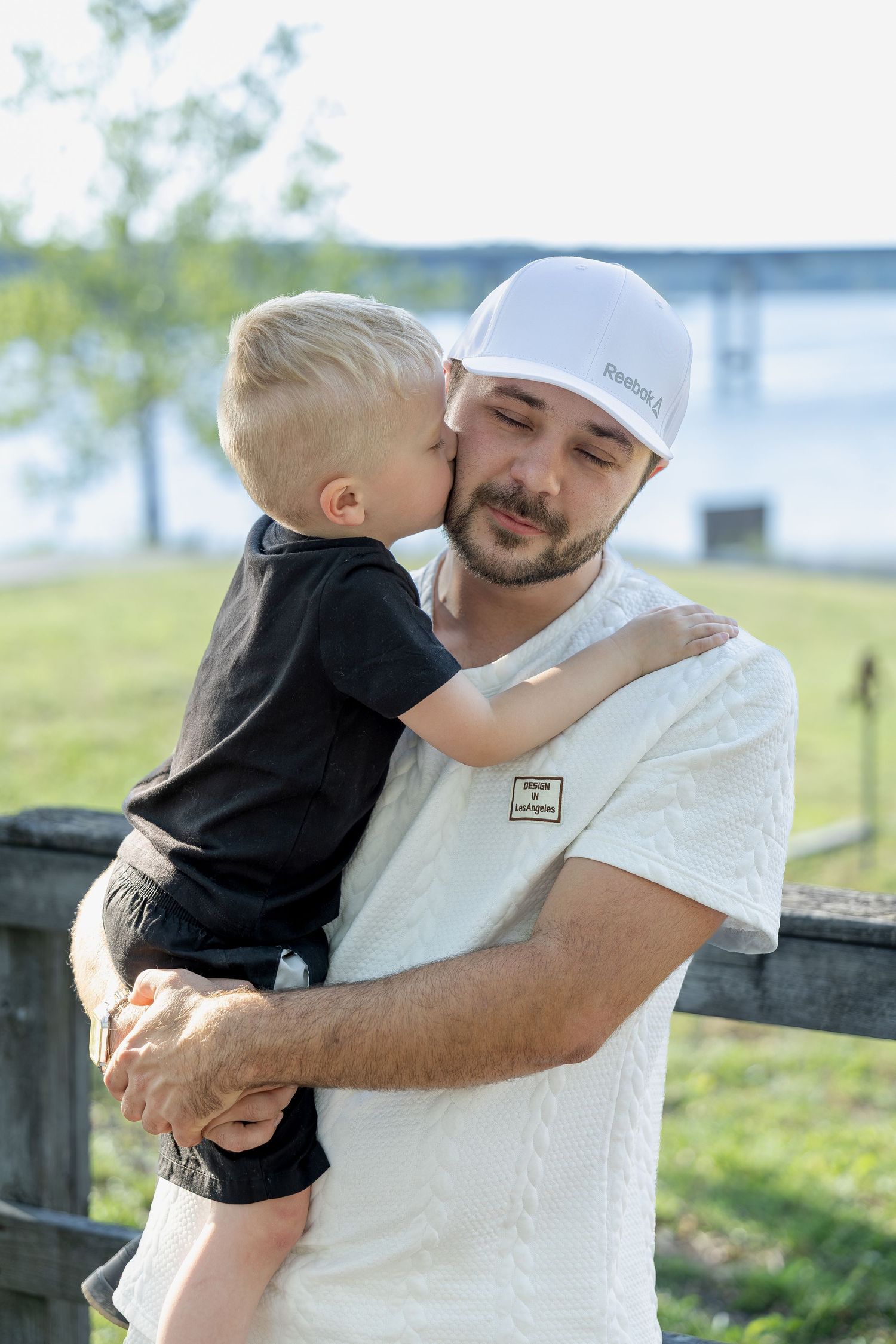 Family portrait session capturing genuine smiles, natural interactions, and timeless memories in a beautiful outdoor setting.