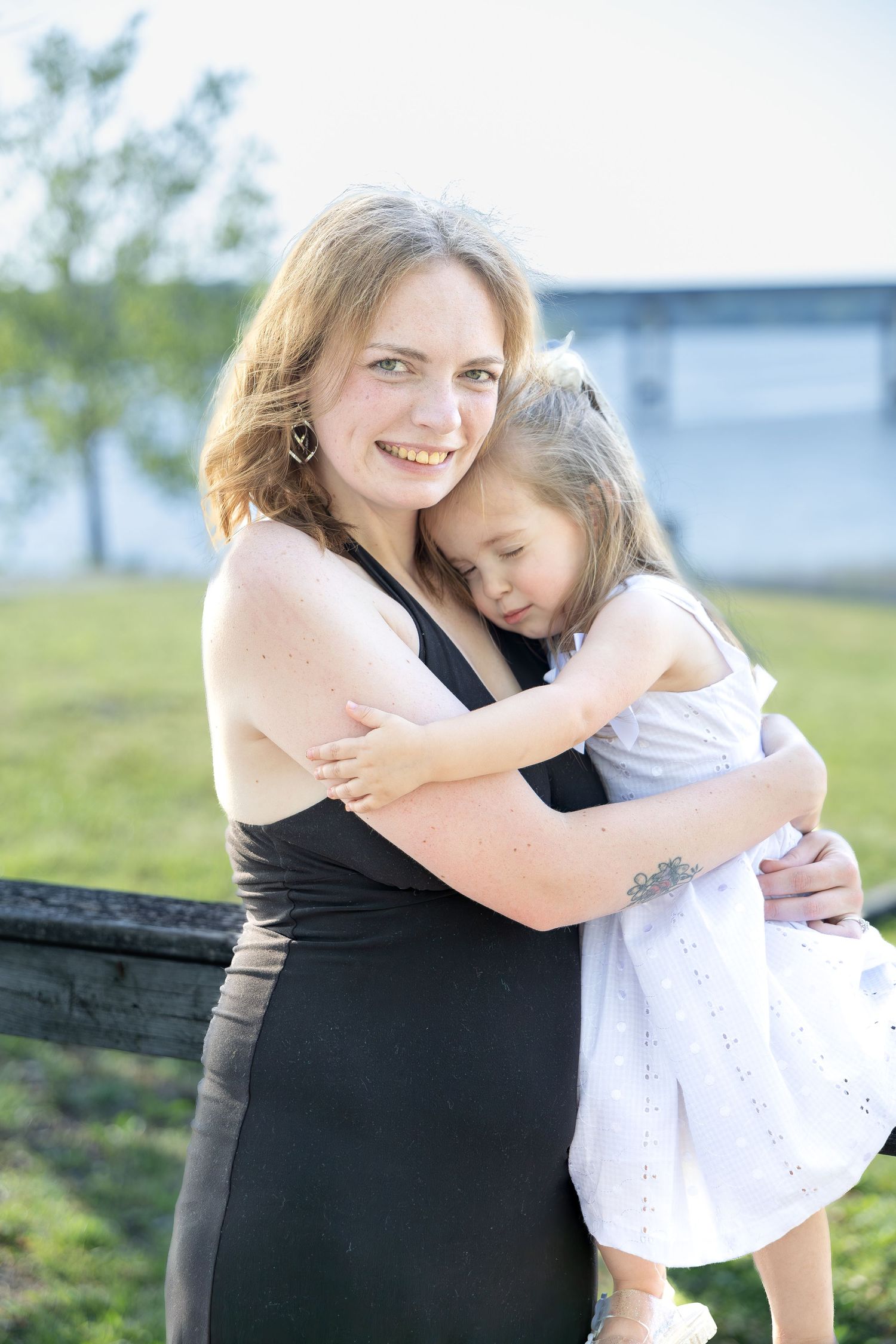 Family portrait session capturing genuine smiles, natural interactions, and timeless memories in a beautiful outdoor setting.