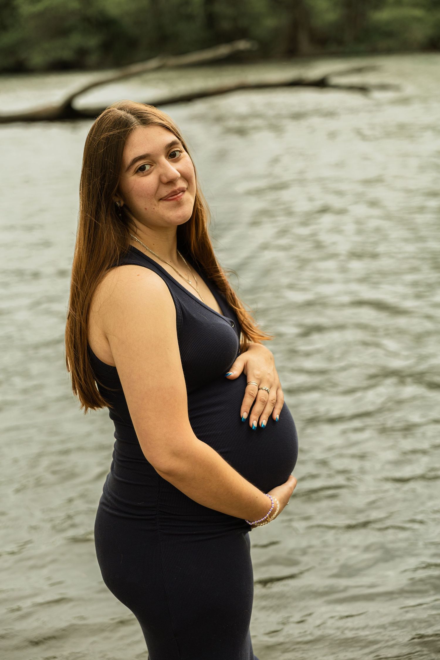 Expecting mother during a maternity session with natural posing, soft light, and timeless portraits celebrating motherhood.