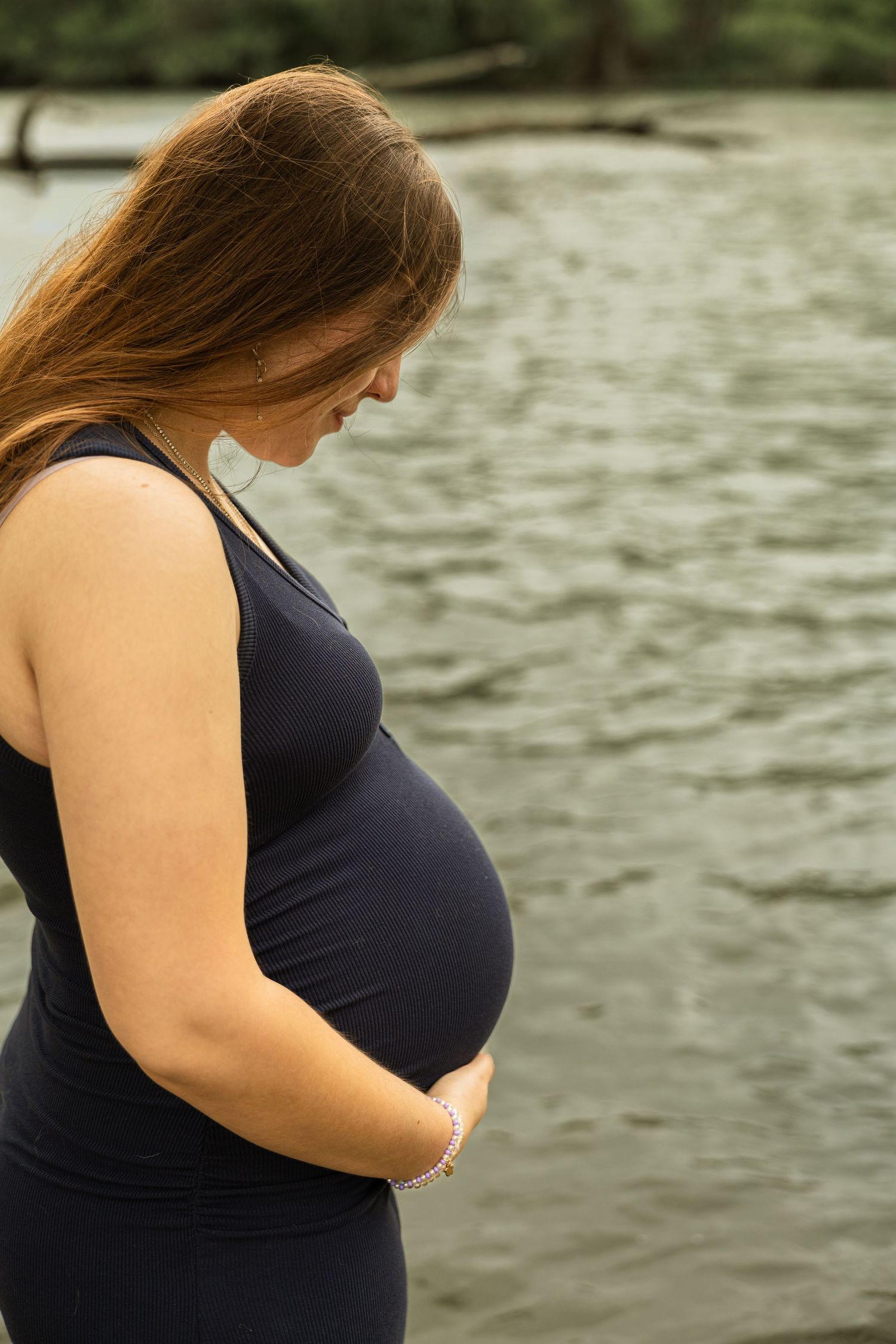 Expecting mother during a maternity session with natural posing, soft light, and timeless portraits celebrating motherhood.