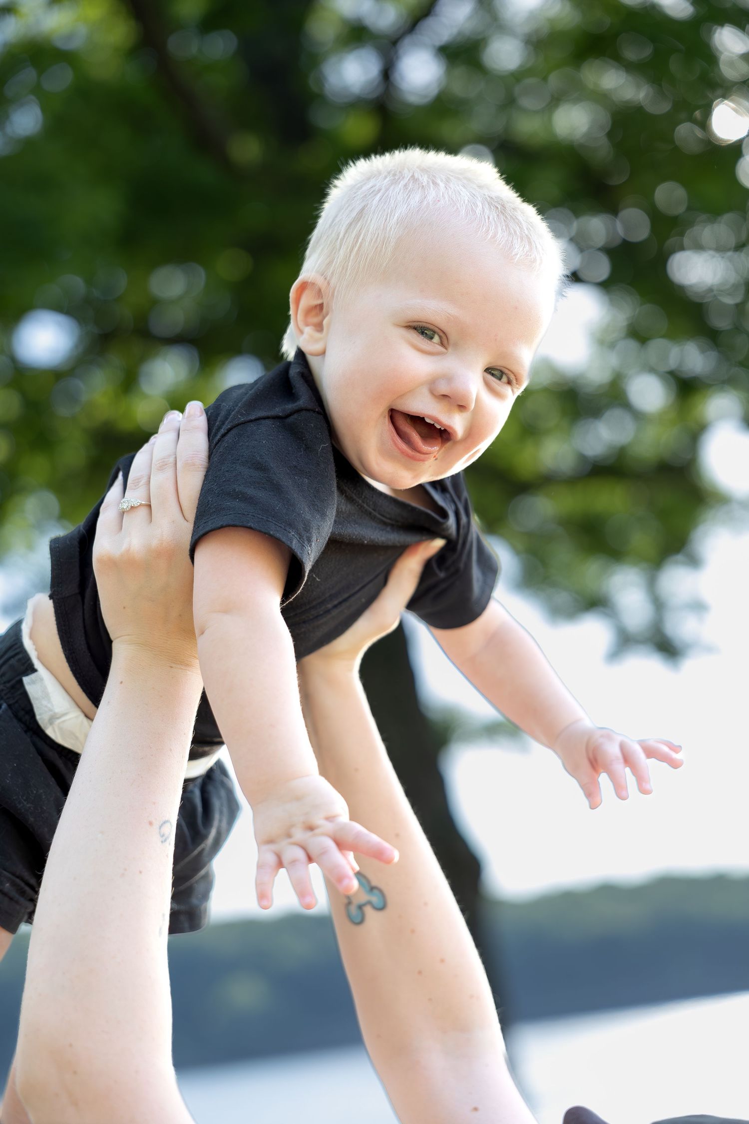 Family portrait session capturing genuine smiles, natural interactions, and timeless memories in a beautiful outdoor setting.