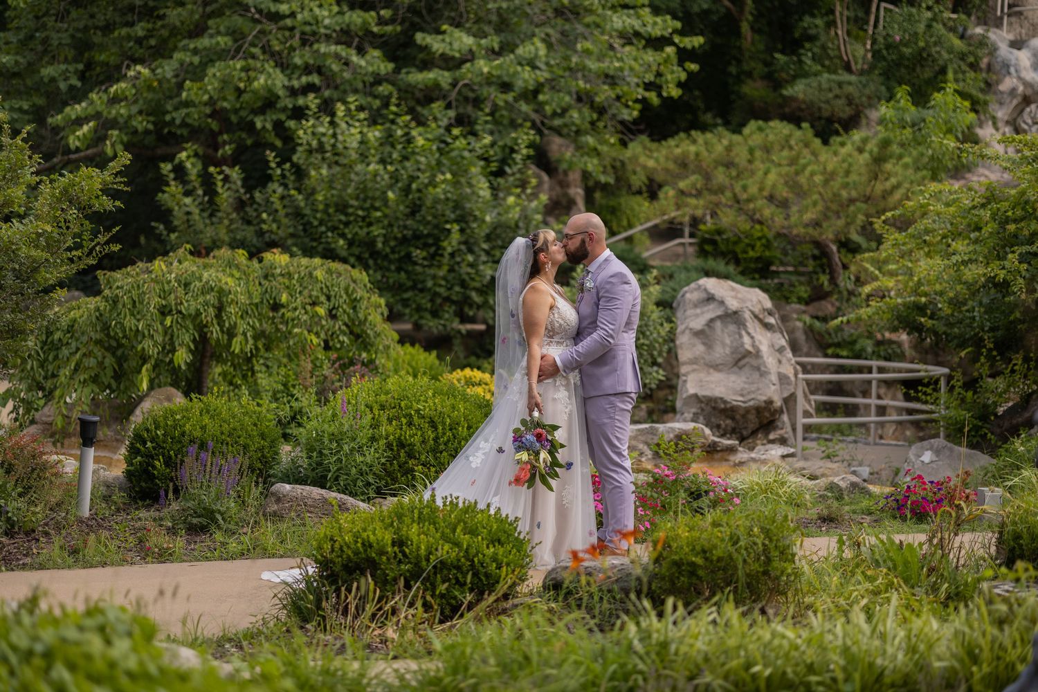 Bride and groom sharing joyful moments on their wedding day with timeless portraits, candid emotions, and elegant details.