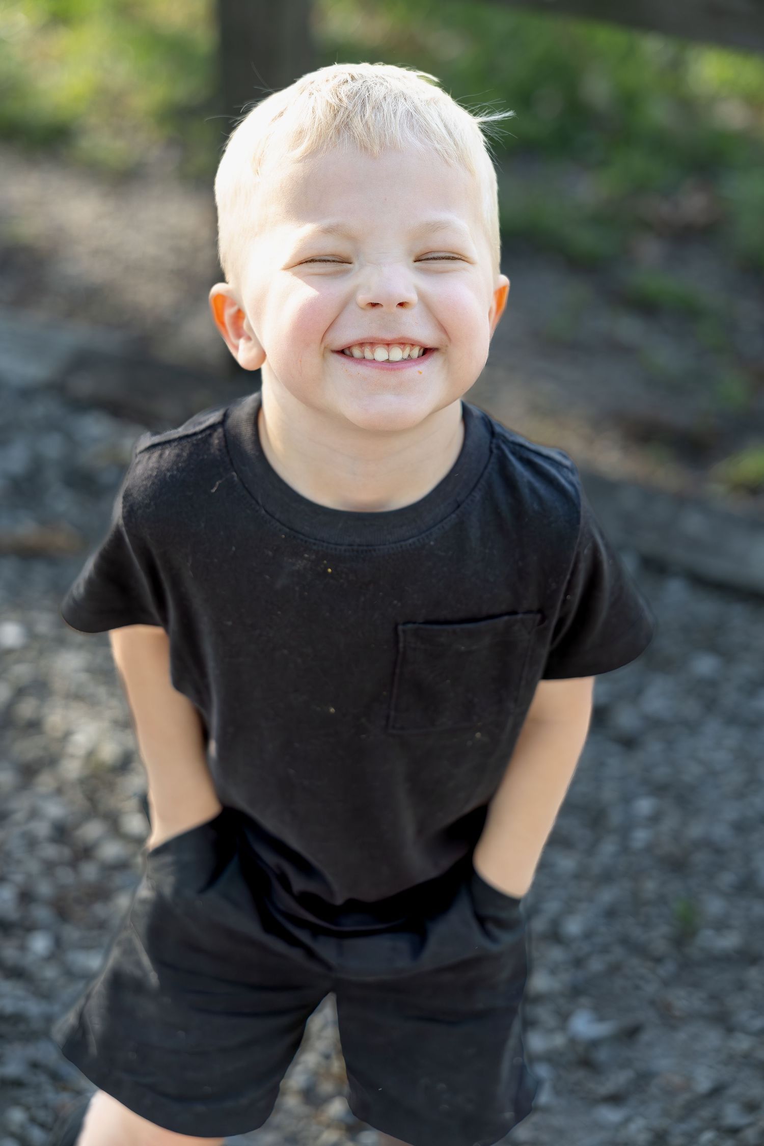 Family portrait session capturing genuine smiles, natural interactions, and timeless memories in a beautiful outdoor setting.