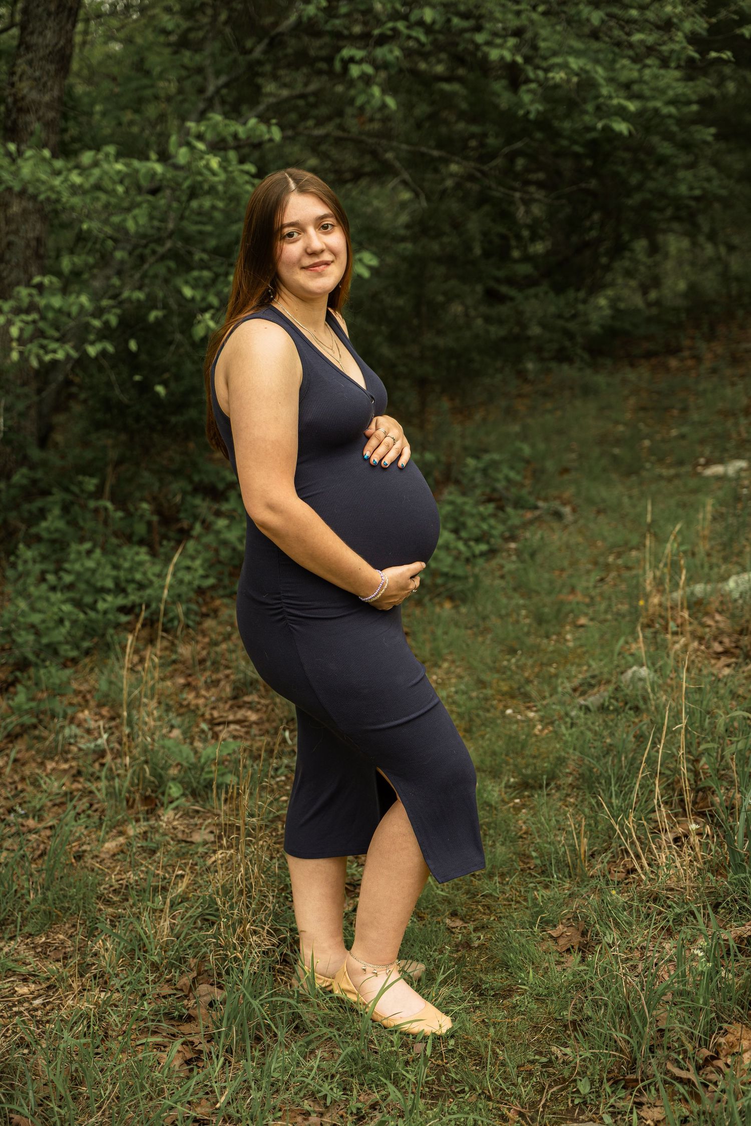 Expecting mother during a maternity session with natural posing, soft light, and timeless portraits celebrating motherhood.