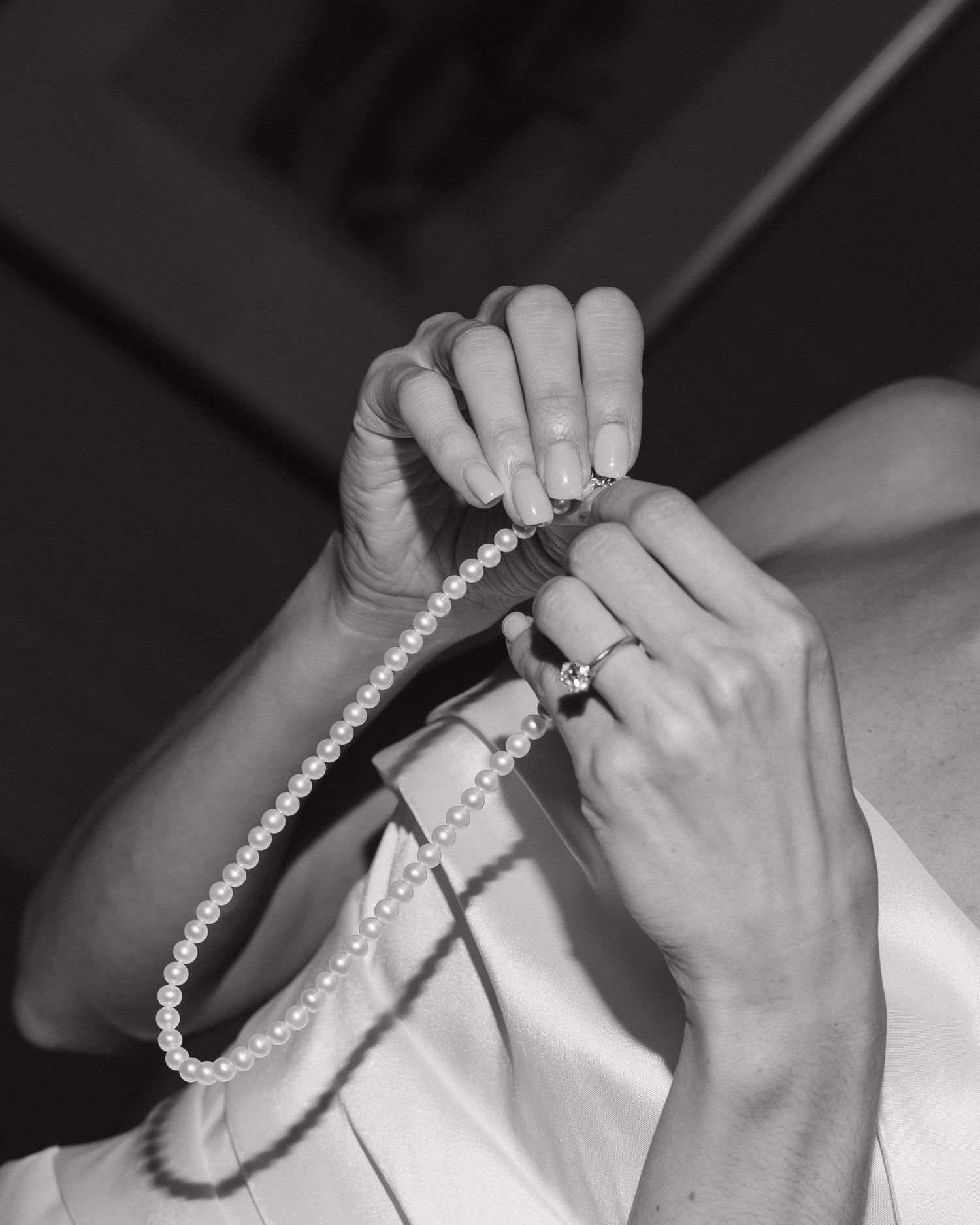 Romanic details of bride getting ready and getting ready to put her necklace on