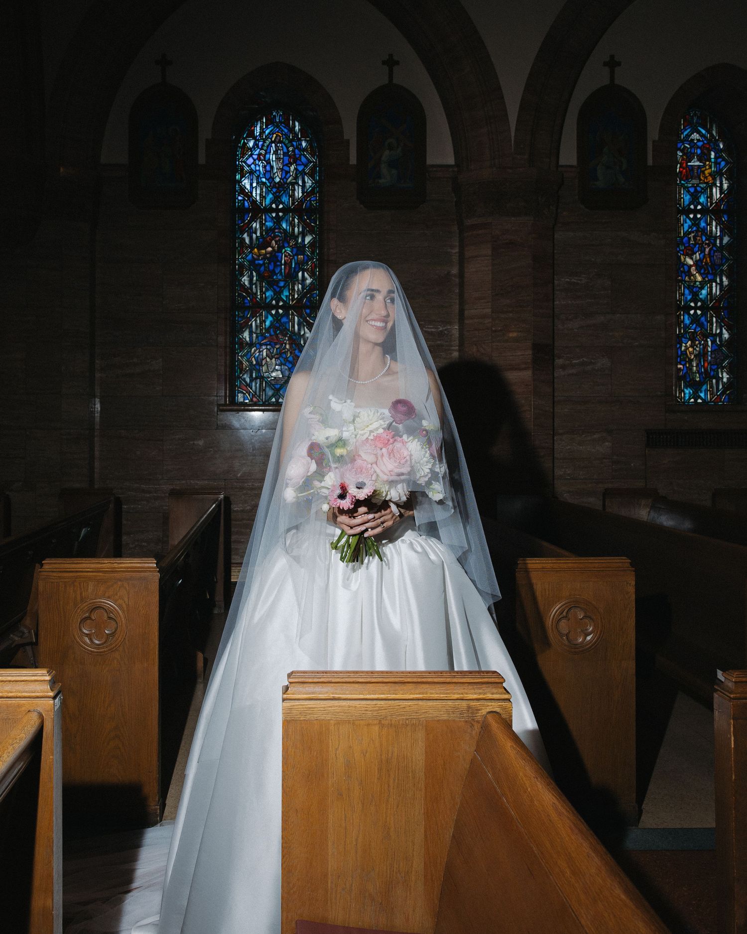 Timeless flash bridal portrait inside a Catholic church with traditional architecture