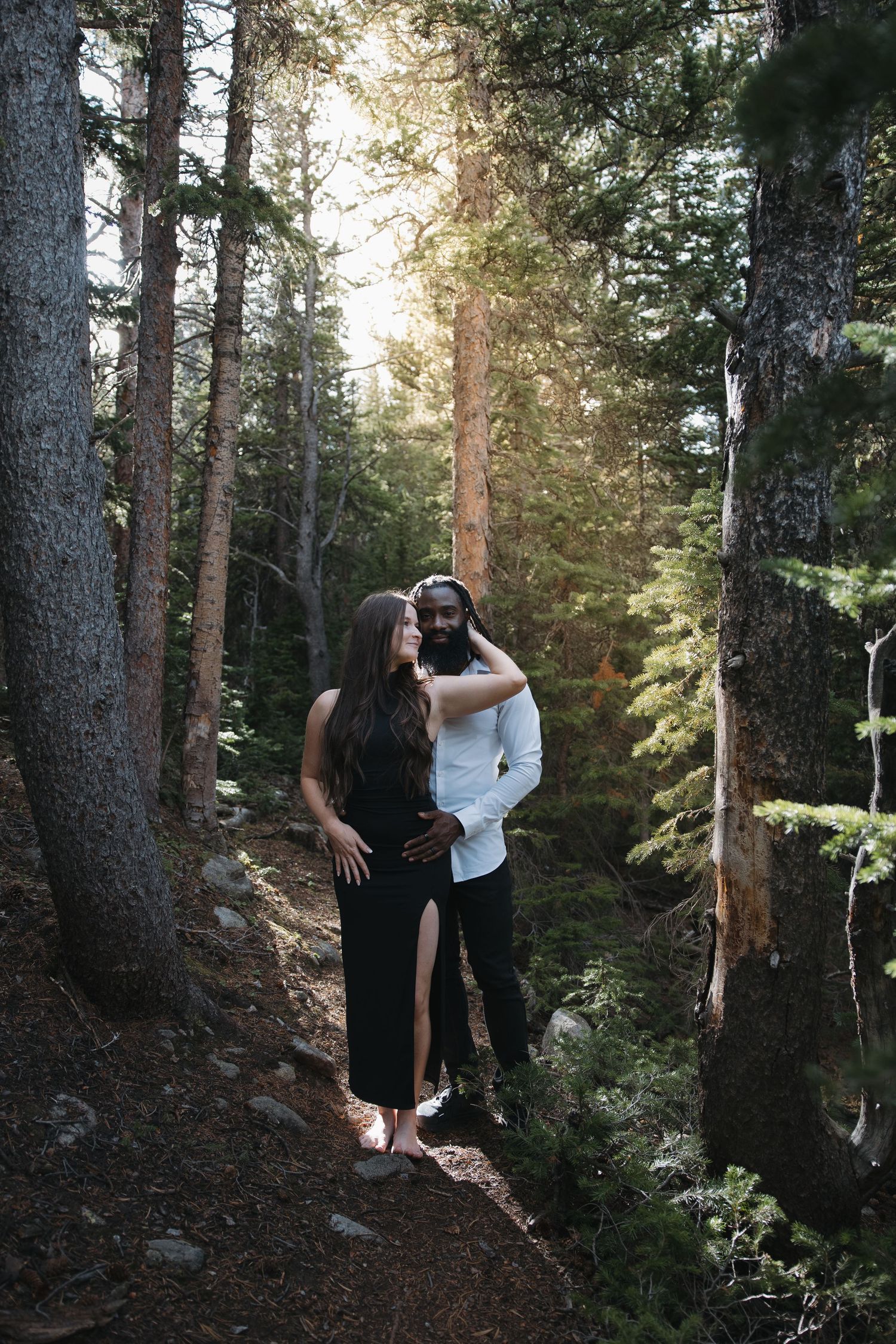 Engaged couple sharing a kiss during golden-hour engagement photography