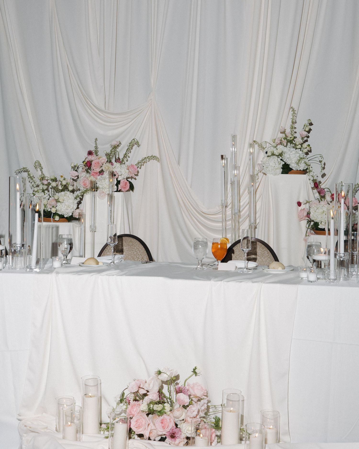 Elegant wedding florals arranged around the head table for a timeless Colorado wedding