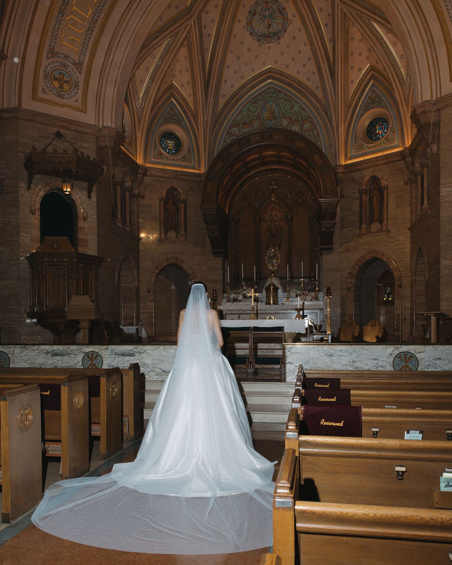 Elegant bridal portrait featuring soft natural light with flash inside a Catholic church