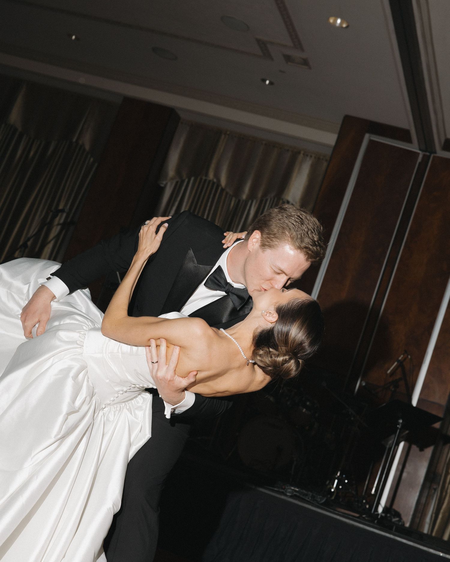 Groom and bride sharing a kiss during their first dance in Colorado