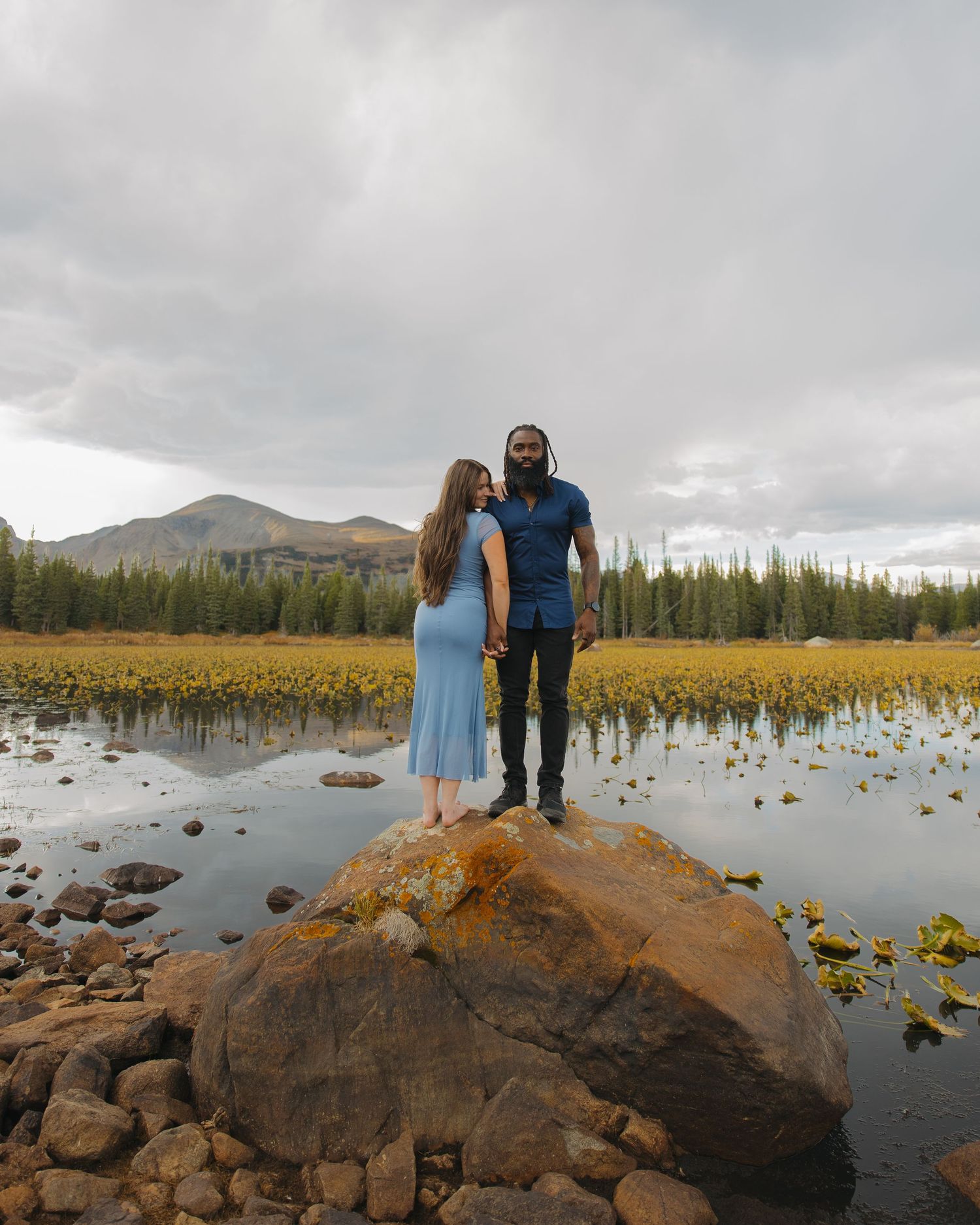 Couple holding hands during a romantic outdoor engagement session in Northern Colorado