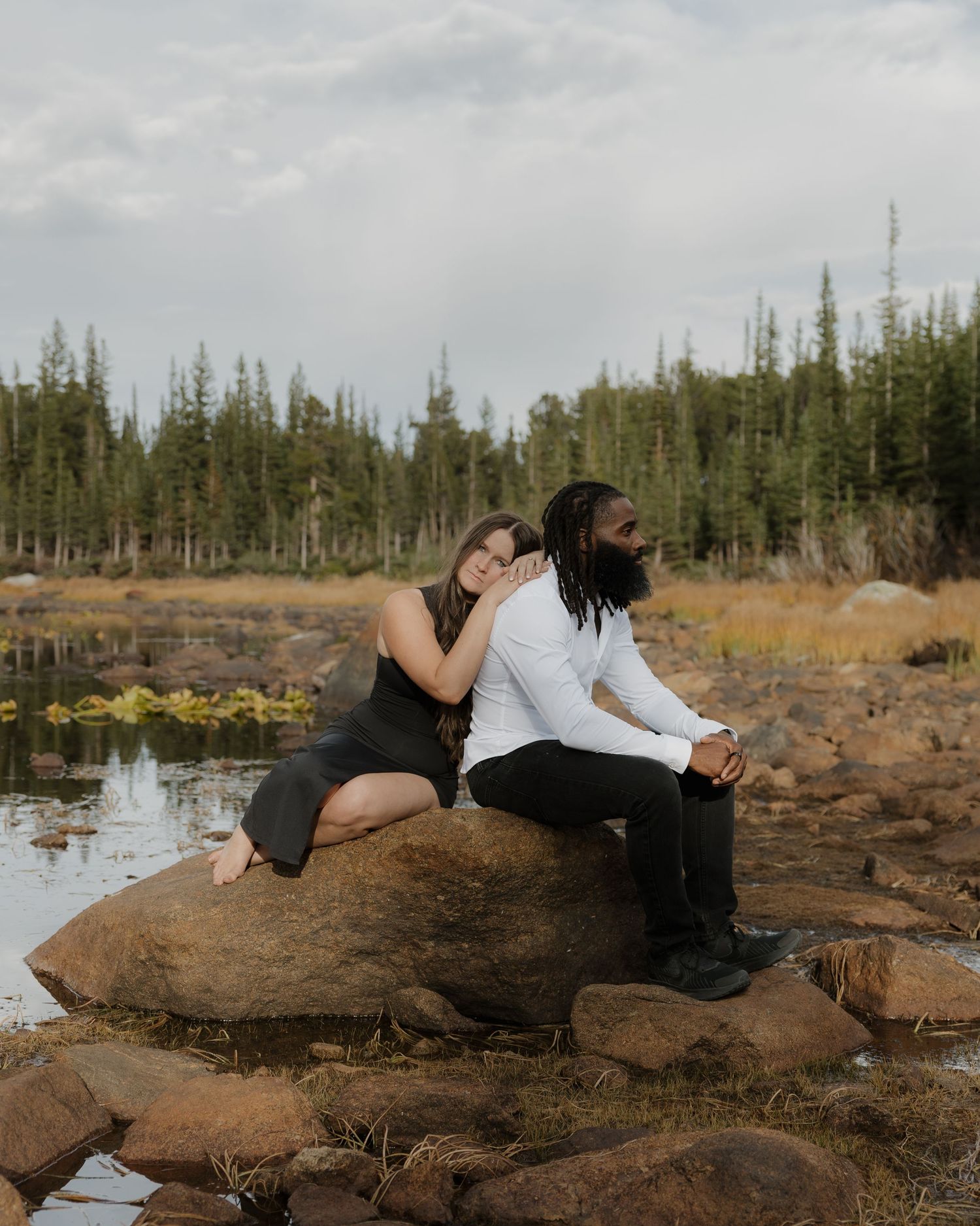 Couple sharing a quiet moment beside a mountain lake in Colorado