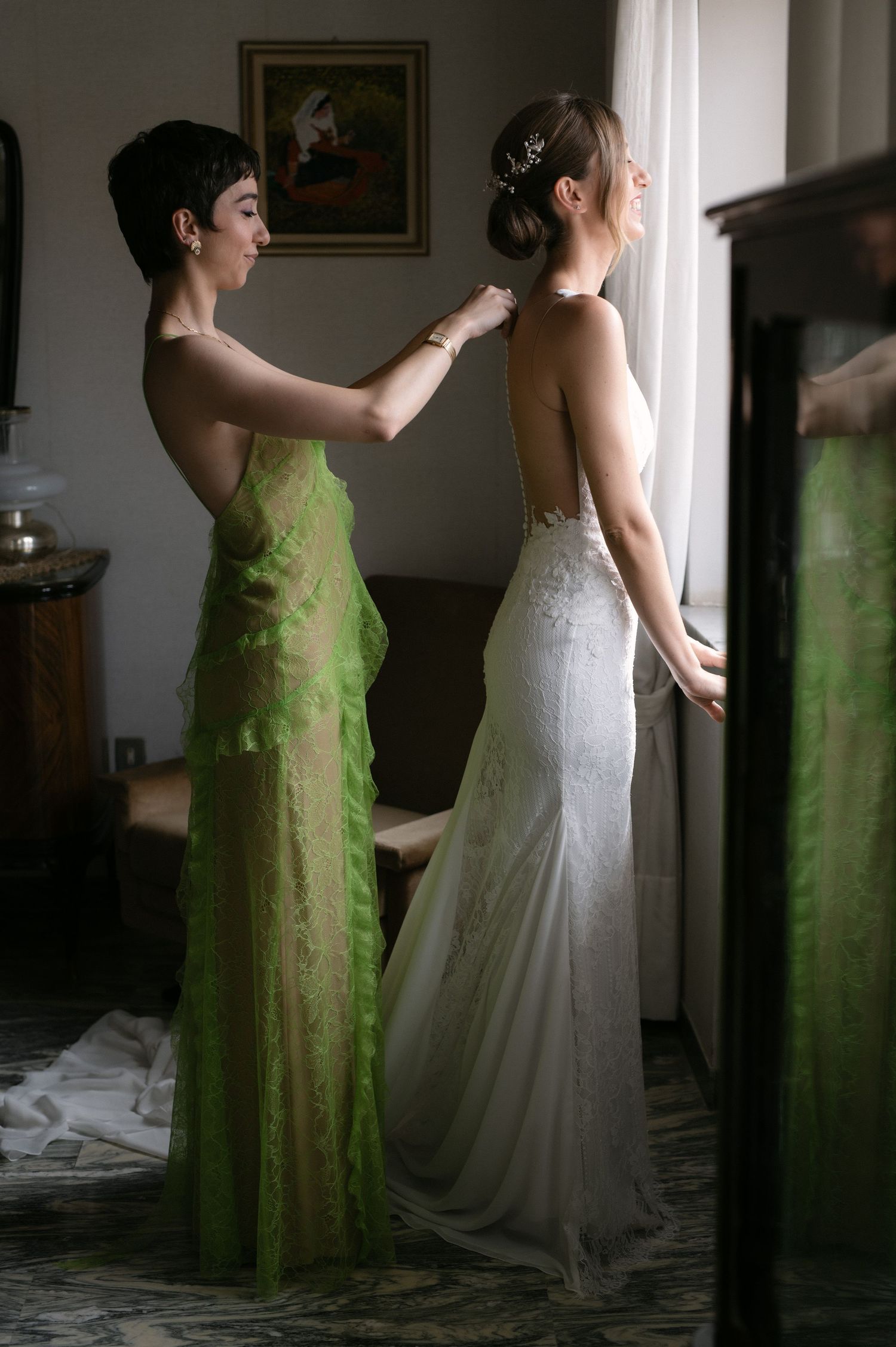 Bride having her wedding dress fastened before the ceremony