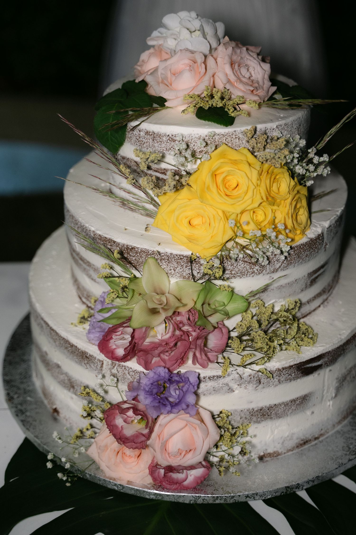 Floral wedding cake decorated with colorful flowers in Sicily