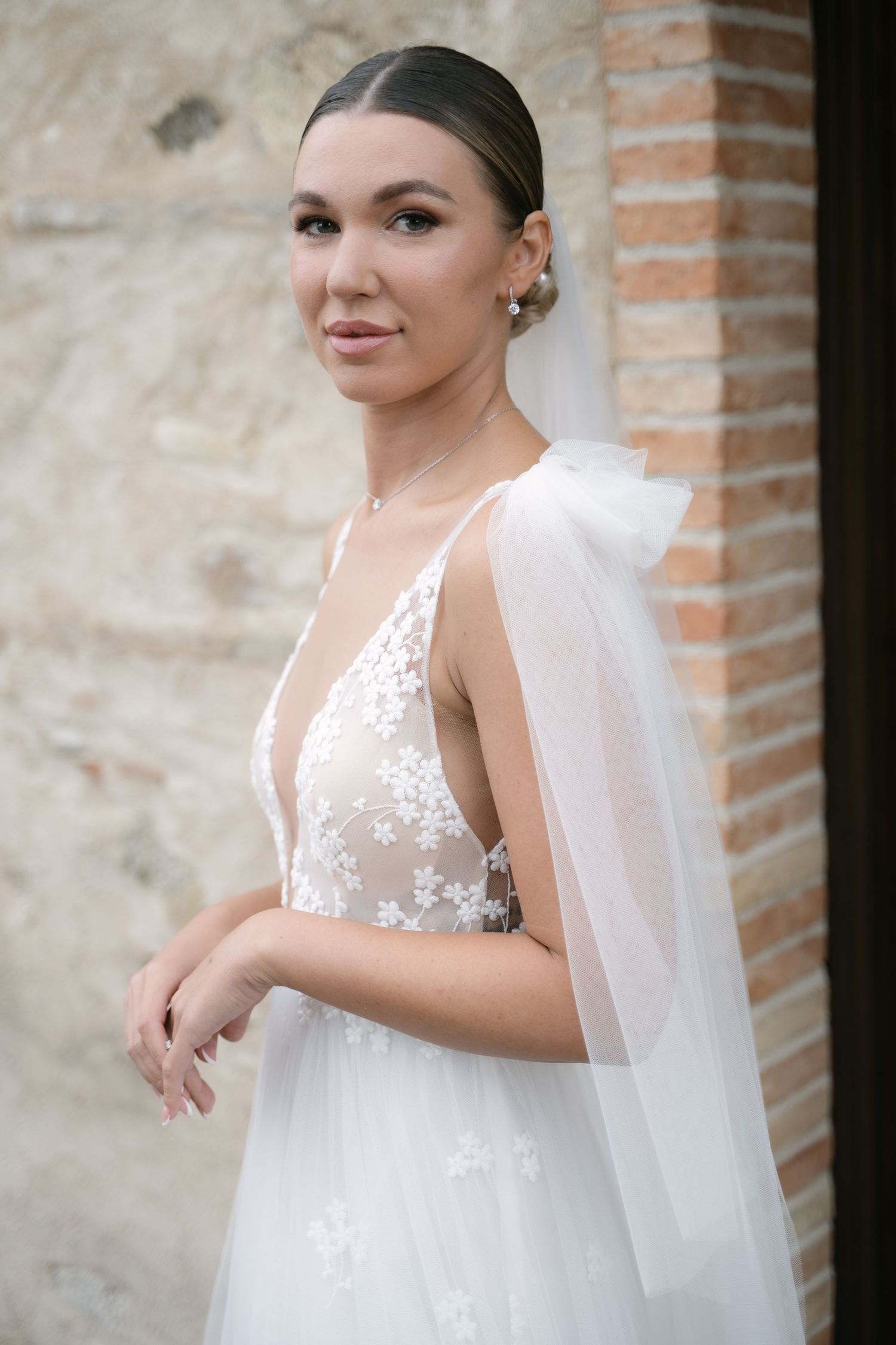 Bridal portrait beside the stone architecture of a Sicilian wedding venue