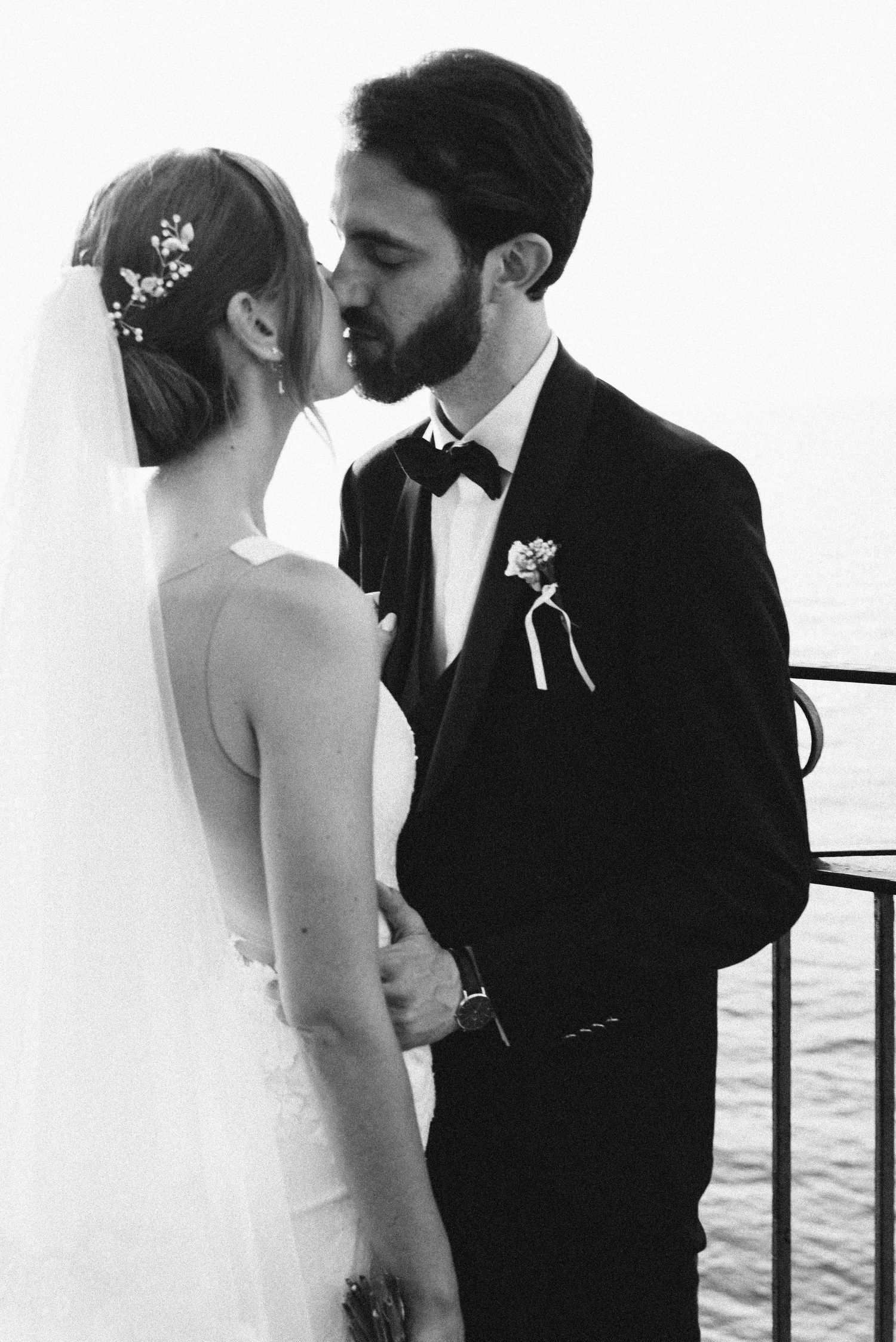 Bride and groom kissing during their wedding portraits