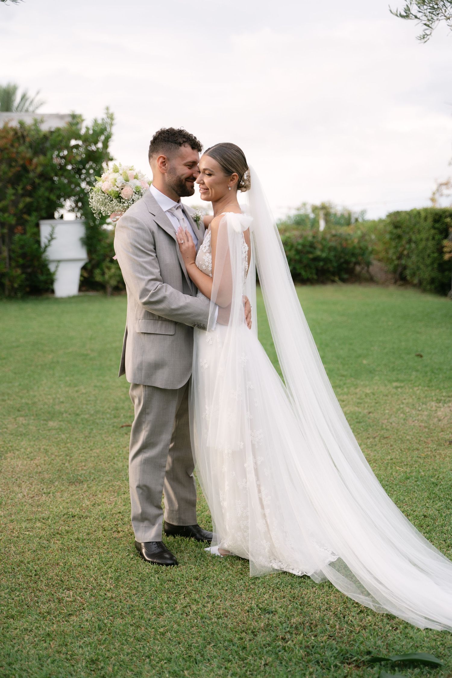 Newlyweds embracing in the garden after their Sicily wedding