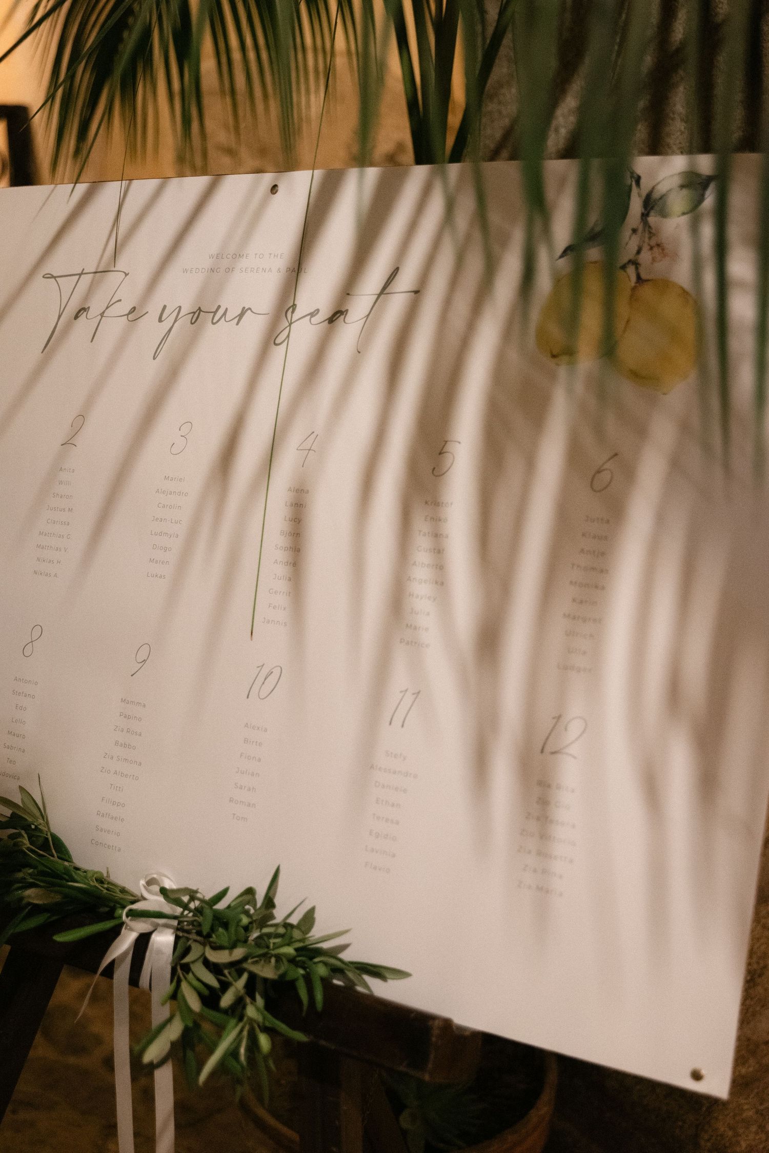 Wedding seating plan decorated with lemons and olive branches