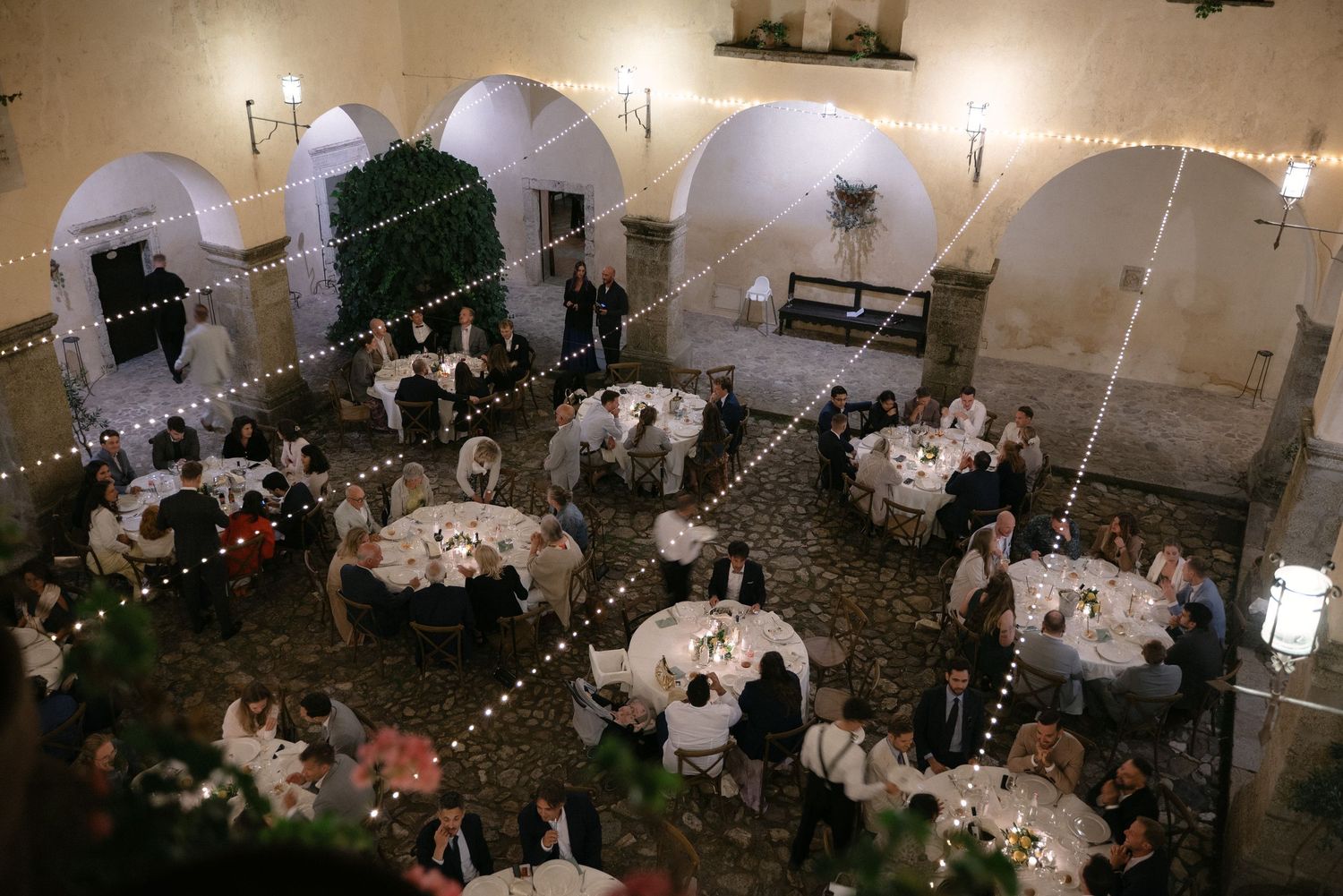 Italian–German wedding reception under string lights in Calabria