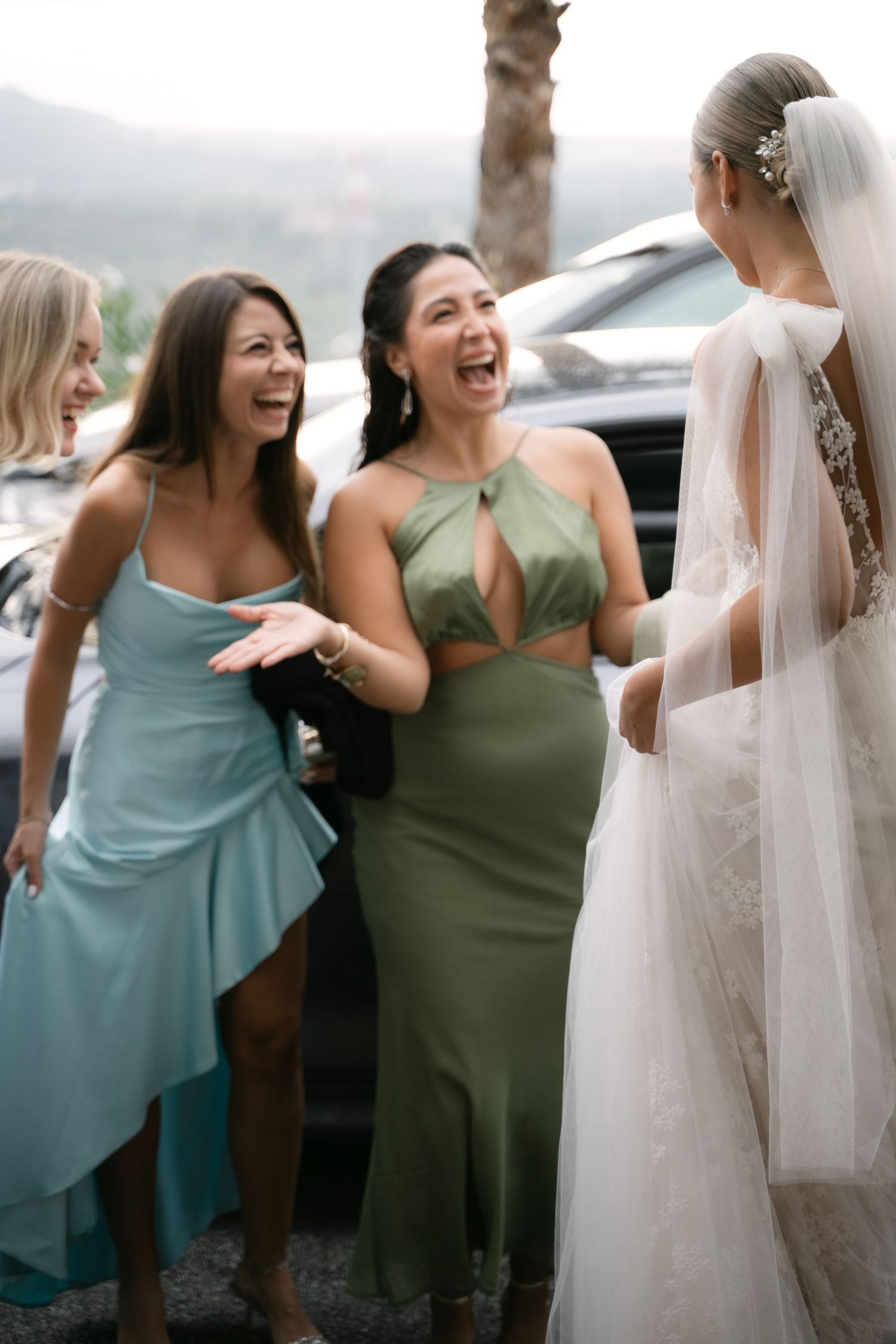 Bride laughing with friends before the wedding ceremony