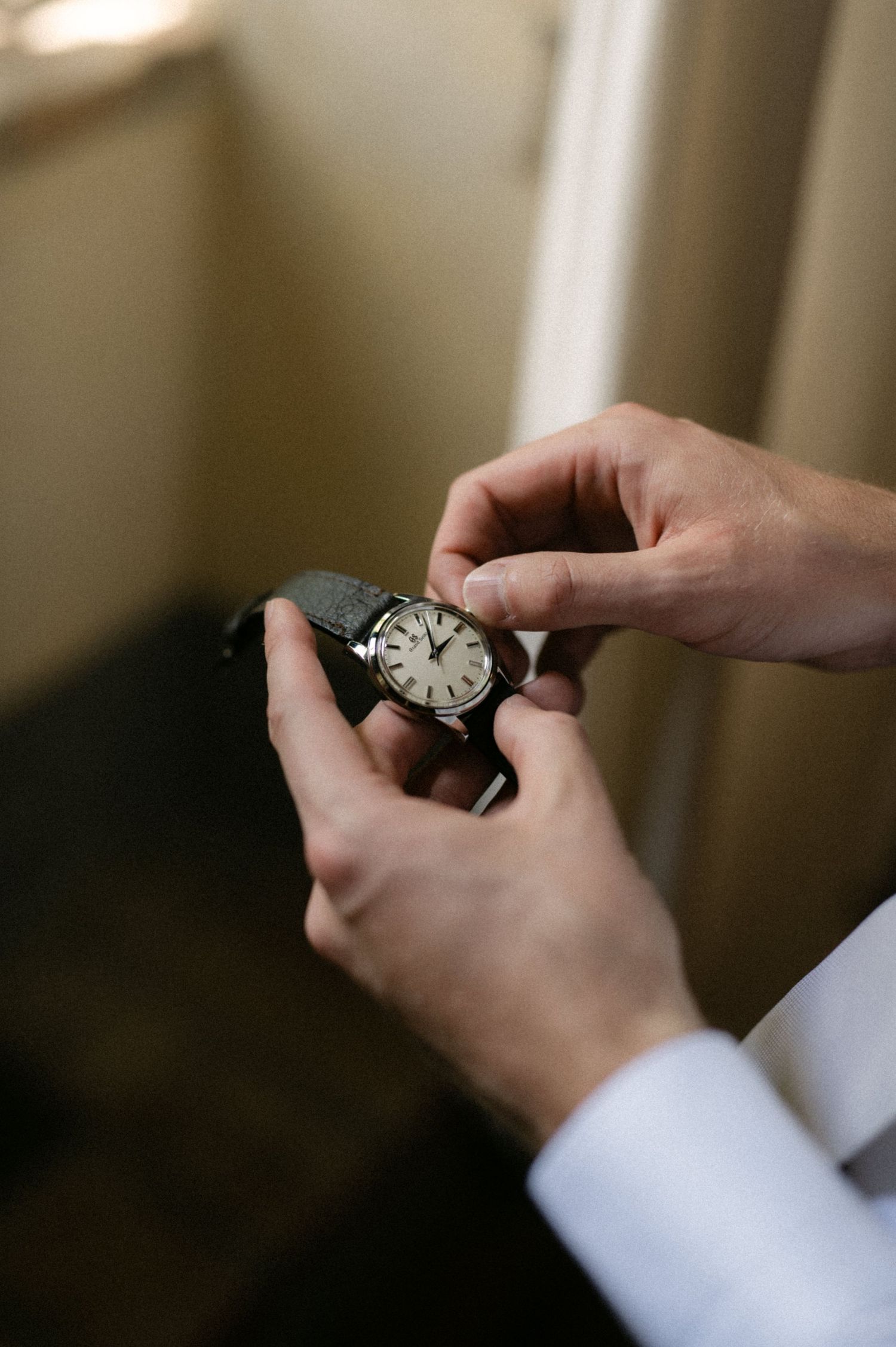 Groom holding his watch before the wedding ceremony