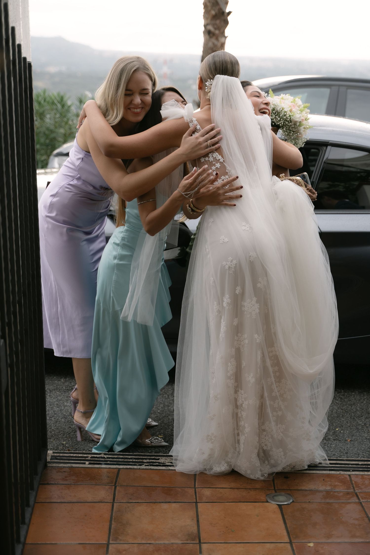 Bride embracing friends during her wedding day in Sicily