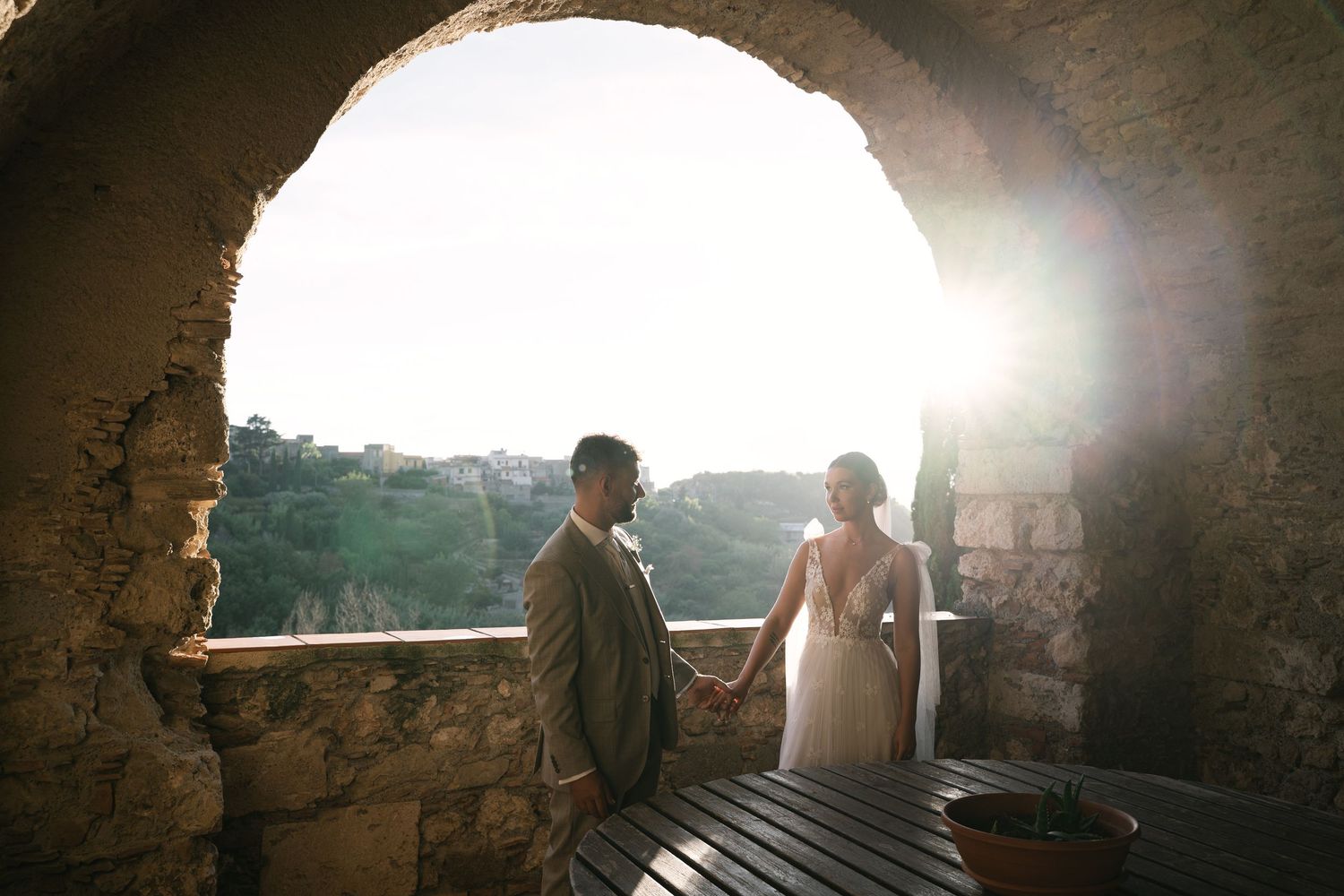 Newlyweds holding hands during sunset portraits in Sicily