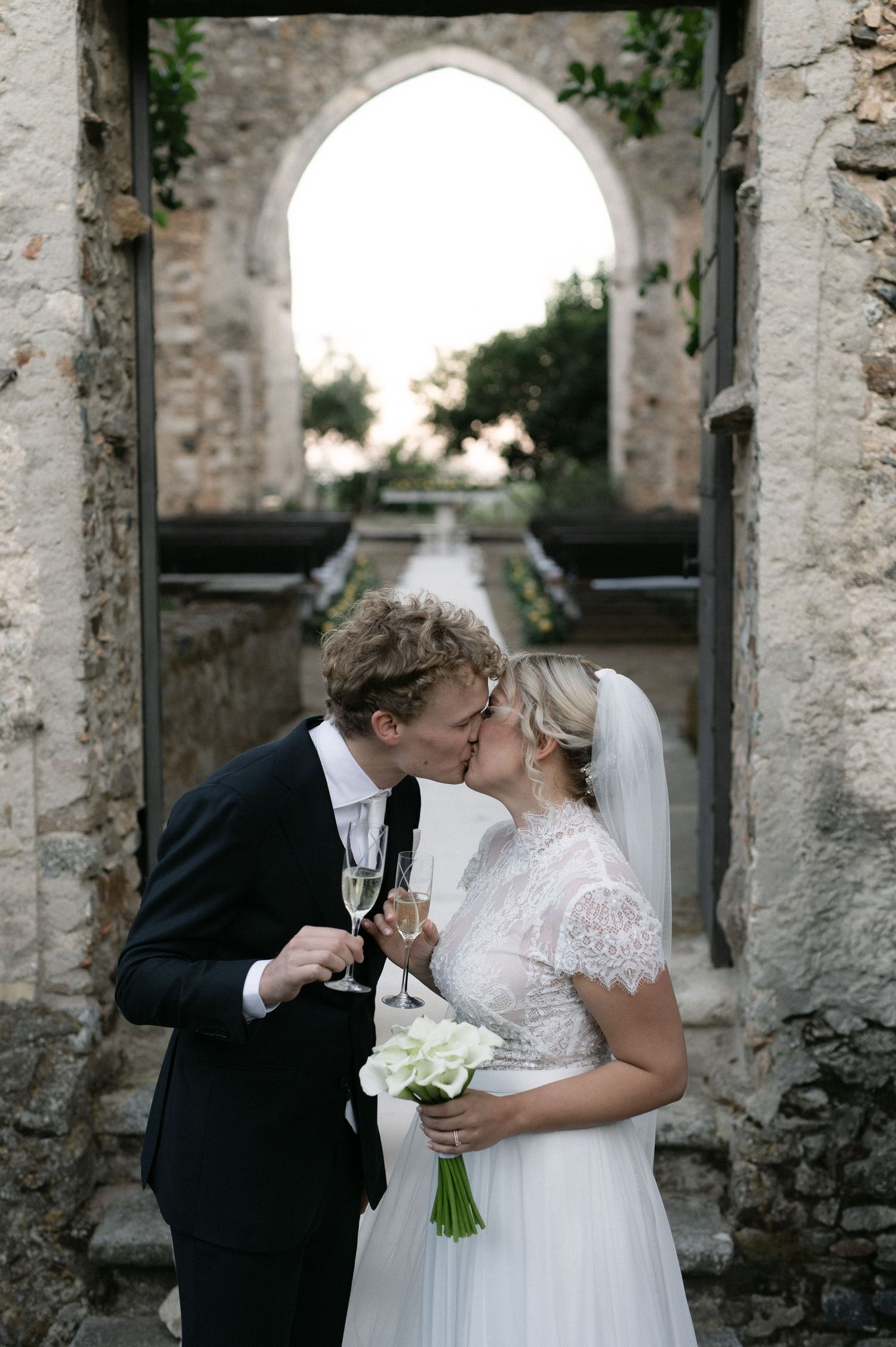 Newlyweds kissing with champagne after their ceremony in Calabria