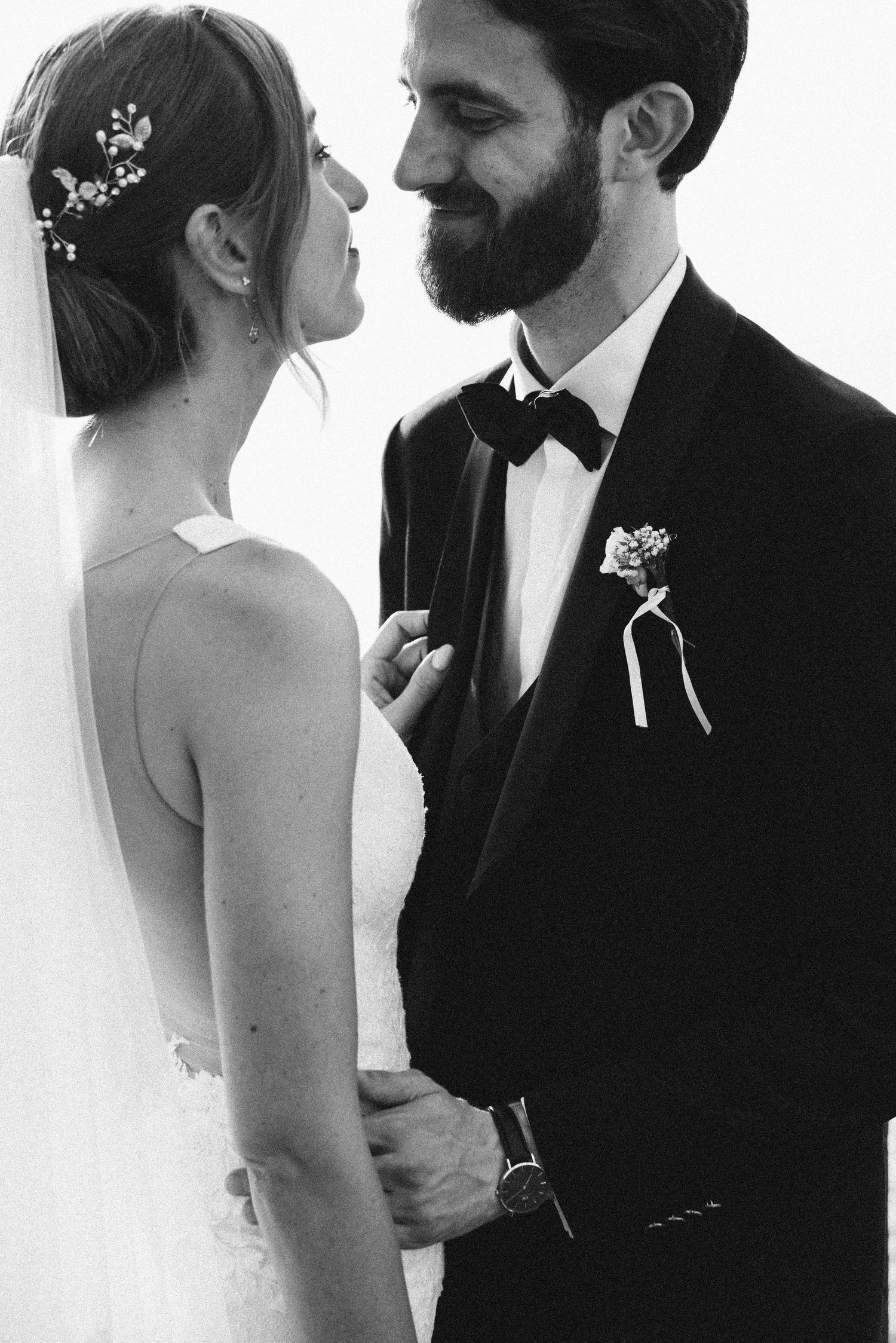 Black and white close-up of the newlyweds smiling together