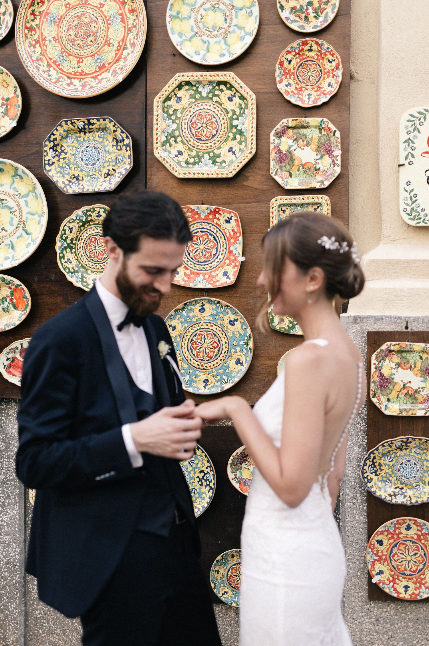 Giulia and Metz beside traditional ceramic plates in Tropea historic centre