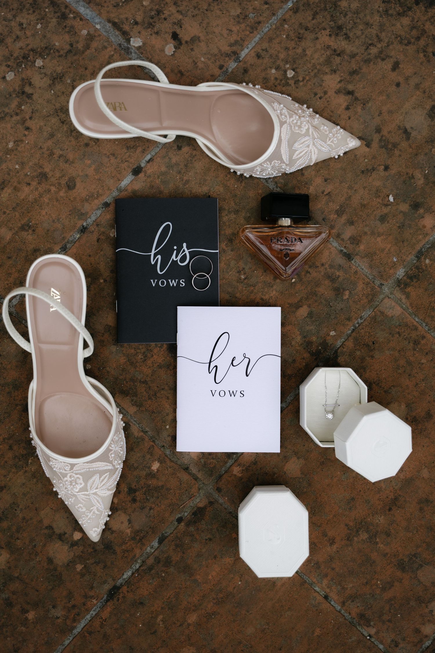 Bridal shoes, perfume, wedding vows and jewelry arranged before the ceremony