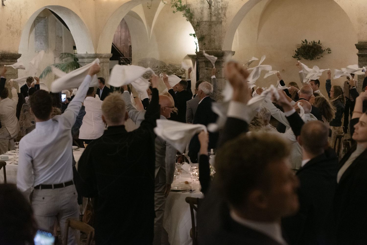Wedding guests celebrating inside the courtyard of Borgo del Convento