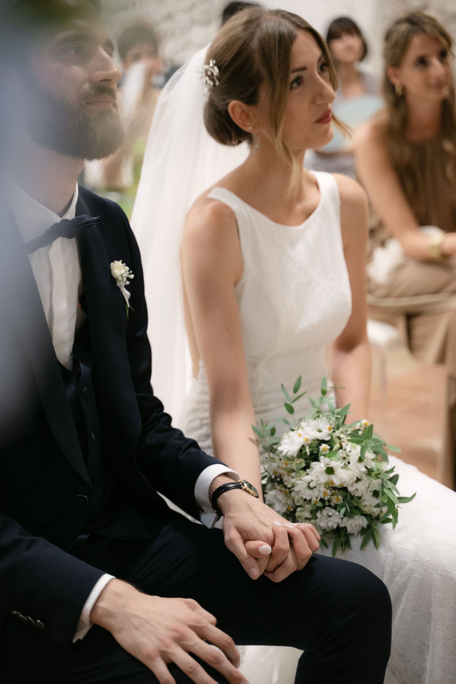 Giulia and Metz seated together during their wedding ceremony