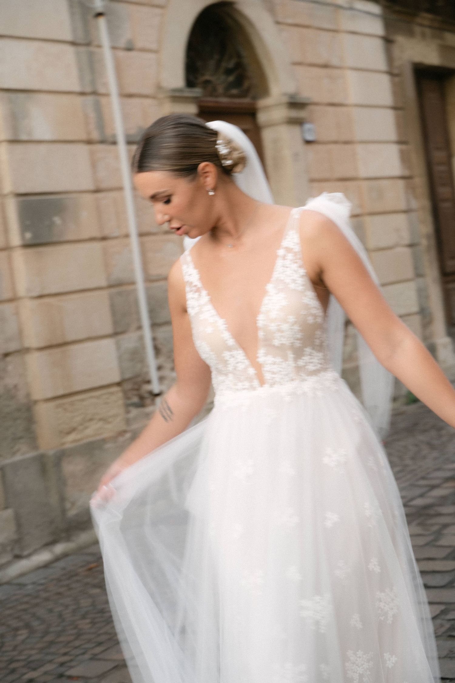 Bride moving her wedding dress during portraits in Sicily